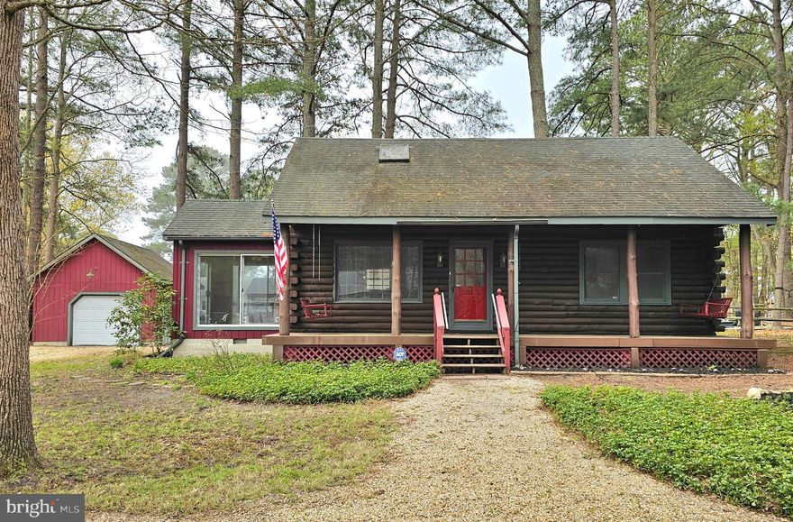 Full of character and tucked into the laid-back waterfront community of Nanticoke Acres, this 3-bedroom log home offers a lifestyle that’s all about slowing down and enjoying the setting. A full-length front porch with twin swings sets the tone, and inside, the home opens to a warm and inviting main living area where a cathedral ceiling creates an immediate sense of space and charm. The kitchen is integrated into this open space, creating an easy, connected flow that feels both functional and welcoming. Two bedrooms, a full bath, and a convenient stackable laundry area are located on the first floor, offering comfortable one-level living if desired. Toward the back, a bright and flexible family room provides additional space to gather, unwind, or spread out—an ideal spot for everything from everyday living to picking crabs with friends and family. Upstairs, an open loft with a shed dormer adds versatility, complete with a private balcony where river views and sunset skies create a setting that’s hard to replicate. Recent improvements include new HVAC, a new water pump and bladder tank, stainless steel dishwasher and refrigerator, and a reverse osmosis system at the kitchen sink. Outside, the property continues to deliver with a 16’x20’ detached garage, a 12’x18’ shed with electric and concrete floor perfect for a home gym, studio, or workspace, plus an additional shed for storage. Nanticoke Acres offers a private boat dock, and you’re just minutes from Nanticoke Harbor, about 30 scenic minutes to Salisbury, and an easy drive to local favorites like the Red Roost. Whether you’re looking for a weekend escape, full-time residence, or investment opportunity, this is a property that captures the pace and charm of the Eastern Shore.