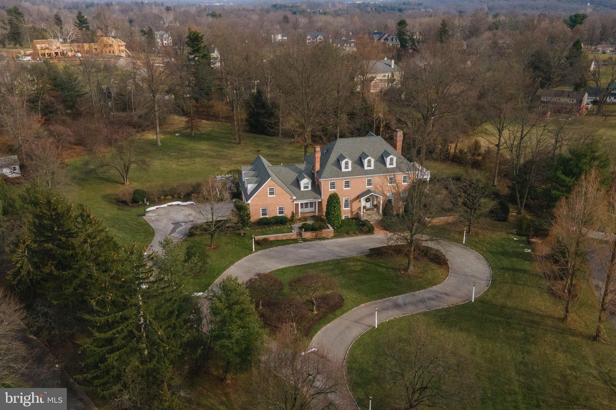 Stunning and gracious custom brick colonial on 2.73 acres in sought after Governor Estates. Six bedrooms, three full and two half baths in over 5500 square feet. Hardwood floors throughout the main level, crown molding and wainscoting. Ten foot ceilings on first and second floors. Two story Foyer opens to a Living Room with pocket doors to the Family Room and Dining Room with gas fireplace. Updated Kitchen with large center island and granite countertops, dining area and French Doors to the patio. Large Family Room with gas fireplace and custom built-ins opens to a lovely Sunroom. A back Den/Office, Butler's Pantry and large Laundry/Mudroom with second powder room complete the main floor. Upstairs is a spacious Master Bedroom with wood burning fireplace, walk-in closets and spa-like Master Bathroom. Five additional Bedrooms, a large Playroom/Bonus Room and two Hall Bathrooms. A curved staircase leads to an unfinished third floor that could easily add additional living space. A large flagstone Patio leads to the spectacular backyard, which offers plenty of room for a pool and endless possibilities for outdoor living. Conveniently located close to transportation, shopping and restaurants of Ambler and Chestnut Hill, with easy access to Center City. Award winning Wissahickon School District. One Year Home Warranty.