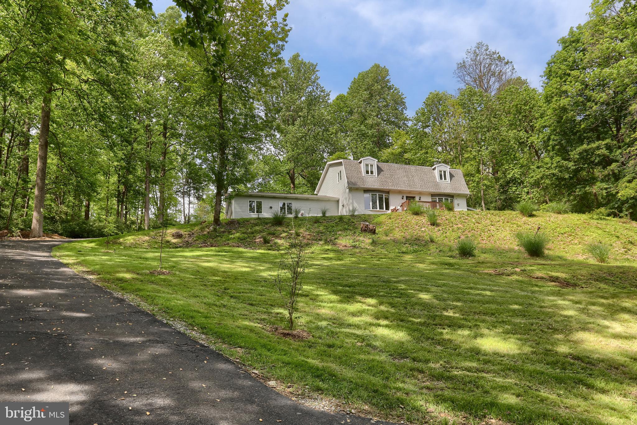 MOVE RIGHT IN to this well maintained and updated home situated on 3.13 acres! When you enter the driveway, you will immediately notice the large detached 2 story garage. This 3 bedroom, 2.5 bath home features a large custom kitchen, spacious living room with beautiful brick wood-burning fireplace, dining room, half bath, mud room with built ins, and a main floor laundry. The second floor features a primary bedroom with full bath and his and hers walk in closets. There are 2 additional bedrooms and a second full bath. The large, finished lower level is a great space and has a pellet stove. There is an unfinished storage area as well. Outdoors you'll find a 30 x 12 rear deck, as well as a 14 x 10 front deck, all overlooking your gorgeous 3+ acres. Plenty of parking in the attached garage or driveway. Schedule your private showing today before this one is gone!