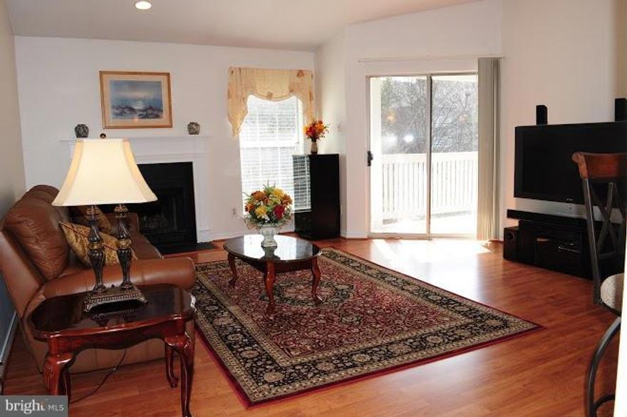 Lovely 2 BR/2 full BA condo on top floor with vaulted ceilings and wood burning fireplace. H/W floors throughout. New renovated kitchen w/granite counters, breakfast bar and brand new SS appliances, recess and pendant lights. Updated bathroom with ceramic tile & granite vanities. Fresh paint throughout. 2 Large walk-in closets. Full size washer and dryer. Huge balcony and storage space.