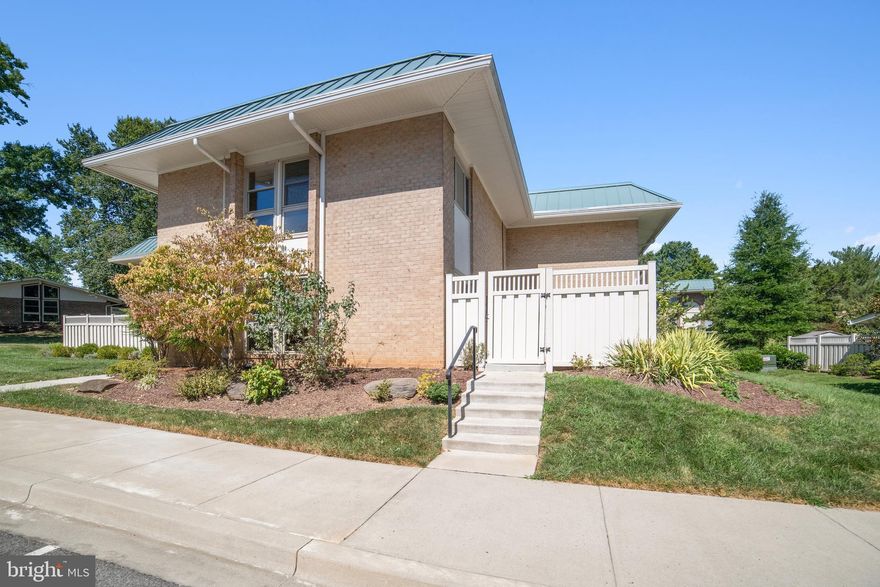 Great space, great price! Come see this updated quad townhouse ( model Arundel) in well-known age 55+ community. Enter this home through a courtyard, and you are met with a bright, open space. Hard surface flooring is throughout - wood laminate in living and dining rooms, ceramic tile in the kitchen and bathrooms, hardwood on the stairs, and hardwood parquet upstairs. On the first floor, the large living room (big enough for a grand piano) flows into the dining room and kitchen. The dining room has a ceiling fan and sliding door to your very own enclosed private patio with storage shed. The kitchen is updated with maple cabinets, granite counters, ceramic flooring, a window over the sink, and plenty of storage and prep area. On this level, you will also find a powder room, a large closet, and a huge storage area under the stairs. The stairway to the upper level is very wide, and has a landing and a very sturdy handrail. On the upper level are 2 spacious bedrooms with triple closets, the laundry closet, and a renovated bathroom. The bathroom has a beautiful tiled shower with grab bars and a seat, and a large vanity with lots of storage and a linen closet. This home is set on a peaceful side street with the Broadwalk and walking trails close by. This gated community has incredible amenities - 2 clubhouses, fitness center, golf, tennis and pickleball courts, restaurants, transportation services, art classes, medical center, clubs, activities, and much more. The monthly fee includes cable TV, high speed internet, all utilities, most maintenance, and property taxes. Right outside the gate is a shopping center with a major grocery store, restaurants, banks, This is a wonderful community in a fantastic location! Please note this is a co-op unit; different contract forms are required.