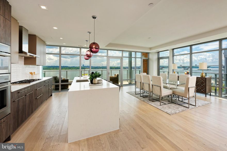 Waterfront Perfection!  Enjoy sophisticated living in this spectacular 3 bedroom + Den, 2.5 bath Robinson Landing penthouse with stunning views of the Potomac River, US Capitol and Maryland shore!  Floor to ceiling windows capture streaming light all day illuminating the spacious living and dining space as well as the sleek contemporary kitchen.  All this has been thoughtfully designed to optimize the water views.  Entertaining is effortless in the living space complete with marble surrounding the gas fireplace.  Breathtaking views from two balconies are unparalleled.  The gourmet chef's kitchen offers endless river vistas, gas cooking, top-of-the-line appliances and European style cabinetry.  A large waterfall edge island with quartz countertops provides ample space for seating or casual dining.  The enviable den is ideal for working from home or as a comfortable place for relaxing.  The primary suite is the ultimate retreat offering a separate sitting area, his/her walk-in closets plus an expansive bath with soaking tub, seamless glass shower and a double vanity with lighted mirrors.  Two additional bedrooms with sizable closets and a stylish bathroom will delight house guests.  A private elevator and 2 deeded parking spaces with an EV charger complete this special property.  This luxurious waterfront community offers exceptional amenities including a fitness center,  pet grooming spa,  a bike room and concierge service.