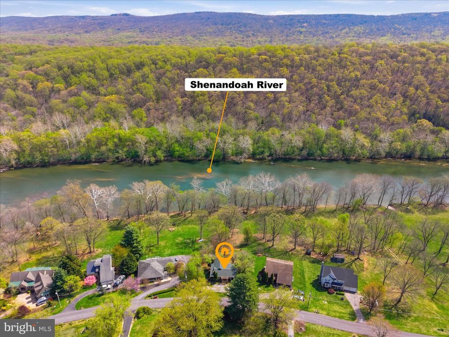 Life on the Shenandoah River has a rhythm all its own, and this property is set up to enjoy it! With river frontage and the house itself located out of the flood plain, this 3 bedroom, 2 bath home offers a rare opportunity to enjoy a true riverfront setting with multiple spaces designed to connect to the outdoors. Upstairs, two bedrooms, a full bath, a living room with built-in shelves, an eat-in kitchen with peninsula seating, and a family room with propane fireplace create the main living area. The larger bedroom and sunroom both open to a screened porch, extending the living space outdoors. The lower level includes a recreation room, an additional bedroom with ensuite bath, and a workshop, all opening to a spacious deck overlooking a water feature and koi pond. From there, a large stairway leads down to the river for kayaking, tubing, and easy access to the water. A charming pergola overlooks a tranquil koi pond, complemented by a picturesque garden arbor nestled in the backyard, perfect for creating a serene, storybook outdoor retreat. Two sheds add practical storage, while the setting itself is what makes this property so memorable!
