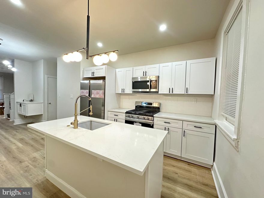 Cozy exquisite interior row townhouse, built in 1925 underwent a major renovation in 2025, offers a harmonious blend of classic charm and modern luxury. With 3 spacious bedrooms and 1.5 elegantly appointed bathrooms, this home is designed for both comfort and style. The combination ceramic tile and luxury vinyl plank flooring creates a warm ambiance, while  pendant and recessed lighting enhances the overall aesthetic. The kitchen is a culinary dream, featuring upgraded countertops, an eat-in space, and a central island that invites casual dining. Equipped with high-end stainless steel appliances, including a built-in microwave, gas oven/range, and dishwasher, this kitchen is as functional as it is beautiful. The bathrooms are thoughtfully designed, showcasing a stall shower and modern fixtures that elevate your daily routine. Ceiling fan in the main living room provide a refreshing breeze, ensuring comfort in every season. Double-hung windows allow natural light to flood the space, creating a bright and airy atmosphere. The partially finished basement offers additional versatility, whether you envision it as a home gym, office, or extra storage space. Outside, the property is adorned with exterior lighting and well-maintained sidewalks, enhancing the curb appeal and inviting you to explore the neighborhood. Parking is convenient with on-street options, and the surrounding area is rich with amenities, making it easy to enjoy the vibrant lifestyle Philadelphia has to offer. This home is not just a residence, it promises to be a sanctuary of comfort and elegance for years to come. Experience the perfect blend of sophistication and warmth in this remarkable Philadelphia townhouse.