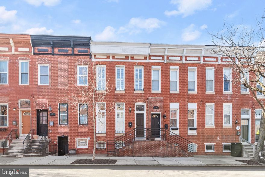 This beautifully appointed interior townhome situated in the vibrant Patterson Park neighborhood of Baltimore offers a lifestyle of convenience and charm. Step inside to discover a spacious main level boasting elegant touches such as two decorative fireplaces, plantation shutters, and stunning hardwood floors that flow seamlessly throughout. The dining area, complete with chair railing and ample storage, leads effortlessly into the kitchen, where shiplap accents, crown molding, and stainless steel appliances create a welcoming atmosphere. Quartz countertops, a decorative backsplash, and an island with a breakfast bar add both style and functionality, while a cozy breakfast area invites relaxed mornings.  Upstairs, the primary bedroom suite provides a tranquil retreat, featuring a vaulted ceiling with a charming brick accent wall, tall windows offering plenty of natural light, two closets for ample storage, and an ensuite bathroom boasting a luxurious glass door walk-in shower and double vanity. Two additional bedrooms, adorned with plush carpeting, share a full bath and offer access to the rooftop deck, perfect for enjoying the views and entertaining guests.  Downstairs, the fully finished lower level provides additional living space ideal for a variety of purposes, from a family room to a home office or gym, ensuring there is room for everyone to spread out and relax. With its desirable location close to shopping, dining, and entertainment options, this townhome presents an opportunity to experience city living at its finest. Don't miss your chance to make this remarkable property your own.  Major commuter routes include US-40, I-83, and I-95.