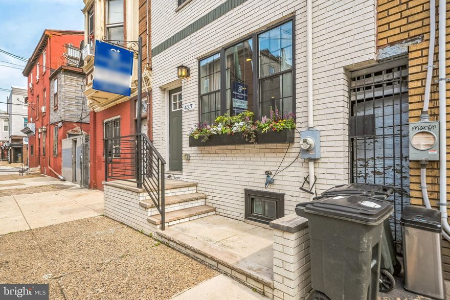 Welcome to 437 Tasker Street, a meticulously renovated 4-bedroom residence that blends timeless character with modern design. Nestled on a desirable 16-foot-wide lot just steps from Dickinson Square Park, this home offers the perfect mix of city living and neighborhood charm. Step inside and be immediately  drawn to the warm exposed brick wall and eye-catching floating staircase featuring 3-inch thick oak treads. The open floor plan flows into a chef’s kitchen adorned with rich herringbone hardwood floors, reclaimed wood accents, and a stunning combination of Carrara marble countertops and premium cabinetry. Top-of-the-line appliances complete this culinary haven. Just beyond the kitchen, a thoughtfully designed private backyard oasis awaits, complete with a built-in bench and ample space for entertaining, dining, or relaxing outdoors. Upstairs, the second floor hosts two spacious bedrooms and a full bathroom with custom tile work and a reclaimed dresser vanity, blending rustic beauty with practical functionality. Continue to the third floor to discover the luxurious primary suite, highlighted by a cozy brick accent wall, a generous walk-in closet, and an elegant en-suite bathroom. Enjoy a clawfoot soaking tub, double vanity, and a large glass-enclosed shower, making it the perfect retreat at the end of the day. On the top level, a versatile fourth bedroom awaits, ideal as a guest suite, home office, or entertaining space with direct access to a private front-facing deck. To complete this exceptional home, the fully finished basement includes a separate laundry room and additional space for storage, fitness, or media. Don’t miss this rare opportunity to own a truly one-of-a-kind home in South Philadelphia. Situated between the Pennsport and Dickinson Narrows neighborhoods and just minutes to all your major conveniences, public transportation, dining, shopping, the italian market, east Passyunk, the sports complexes and much more! Schedule your tour today!