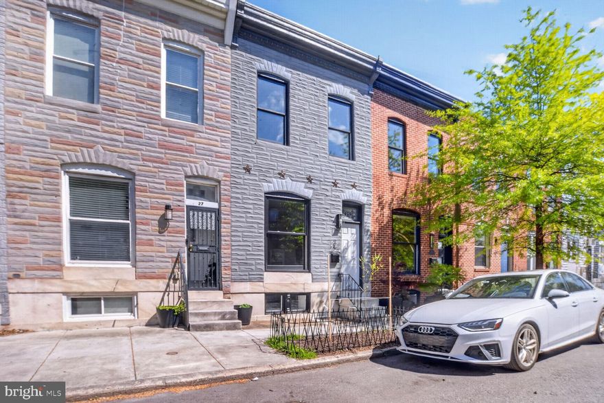 Welcome to 25 N Ellwood Ave, a charming rowhouse that blends historic character with modern updates throughout. Renovated in 2022 and recently painted from top to bottom, this stylish home is ready for you to call it your own. The classic marble stoop, tile vestibule, and beautiful stained-glass transom window set a characterful tone in the entry hall. The main floor offers flexible living and dining spaces, while the kitchen has ample storage, workspace, and stainless steel appliances. Keep your outdoor gear tucked away in the convenient mudroom leading to a private rear patio that can double as secure parking if needed. A skylight brightens the upstairs featuring a spacious primary suite with ensuite bath, plus a large second bedroom and full hall bath. The lower level bedroom adds versatility with a convenient full bath. Alternatively, the space is ideal for an office, media room or home gym. Fantastic location near Patterson Park, Canton Crossing, and easy access to Downtown and I-895. Bonus: the remaining CHAP tax credit offers potential savings to a new buyer. Don't miss this inviting home!