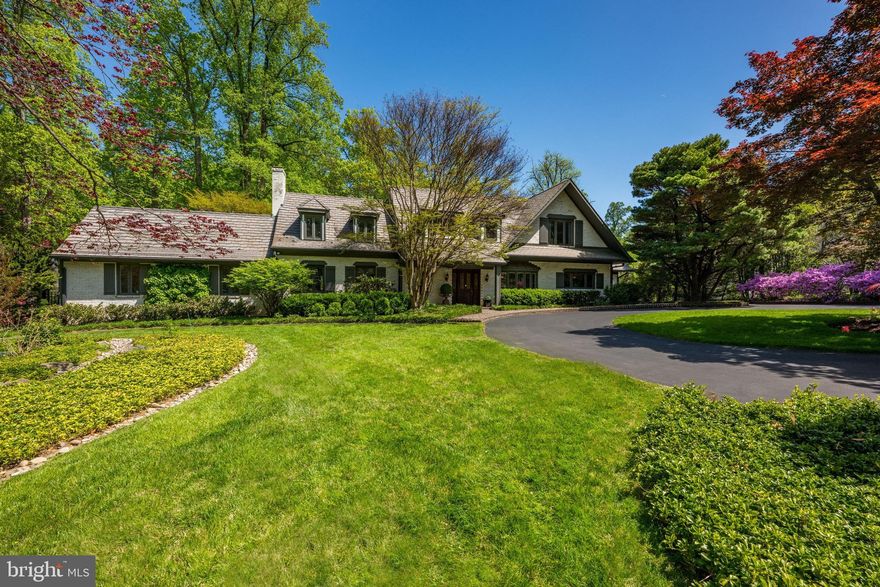 BEAUTIFUL SETTING - nestled on one of Bethesda’s most scenic streets, this home offers a rare blend of seclusion and convenience on a lush 1.6-acre lot. This stunning property is a true oasis, where mature landscaping frames a sparkling pool and sprawling lawns. Expansive brick patios are tailor-made for entertaining, providing a tranquil retreat just minutes from the vibrant heart of downtown Bethesda, elite schools, and major commuter routes.  A private circular drive welcomes you to this storybook expanded English cottage. The inviting foyer opens to a thoughtfully designed floor plan, starting with a grand living room with a fireplace and an adjacent formal dining room. The main level also includes a quiet study with two custom desks & shelving and a family room with stone fireplace, exposed beams, and glass doors leading outside. The elegant gourmet kitchen is well-appointed with a large center island and sunlit breakfast area. A first-floor bedroom suite offers a dedicated office, en-suite bath, and direct backyard access. Completing this level are two powder rooms and a mudroom conveniently located off the 2-car attached garage. Upstairs, the owner's suite is a true retreat, featuring vaulted ceilings, window seats overlooking the yard, a sitting area with a fireplace, a dressing area, and 3 walk-in closets. The luxury bath includes a soaking tub, oversized shower, and dual vanities. Bedrooms #2 and #3 are both generously sized with walk-in closets and share a Jack-and-Jill bathroom. Bedroom #4 includes double-door closet and en-suite bath. This level is completed by a large landing with built-ins and a convenient laundry room. The lower level offers additional versatile space, including a family room (or guest bedroom) with an adjacent full bath, a recreation room with extensive storage, and a powder room.