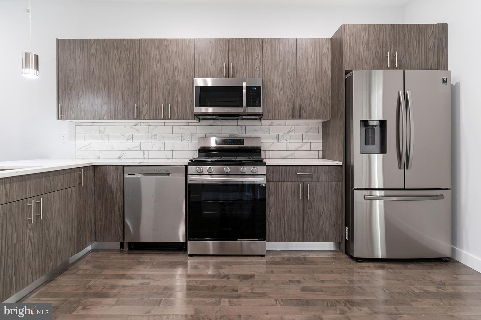 Boasting toasted oak hardwood flooring, a fully-loaded kitchen, private outdoor space (hello, roof deck), and central air, 1947 N 7th St #3 comes equipped with everything you need to feel right at home. Upon entry, you are greeted by an open living and dining concept. The room is soaked with sunlight thanks to the oversized windows. Whether you're a Grub Hub gazelle or a meal prep maniac, the kitchen offers stainless steel appliances, driftwood cabinets with brushed nickel hardware, calcutta quartz counter tops, and contemporary pendant lighting to support any culinary lifestyle needs. This flat offers two functional and sizable bedrooms, each with their own respective full bathrooms and dedicated closet spaces. Washer/dryer in-unit. Recessed lighting throughout. Private intercom system and smart thermostat! $40 application fee per applicant. Generally, first, last, and security are due upon signing. $35 flat water fee per month. Pet-friendly. Walking distance to Temple University, Cousin's Supermarket, Human Robot Beer, Luna Cafe, the Broad Street Line. Easy access to all the happenings in Fishtown, Broad St/611, and Girard Ave. Available 6/15/2025.