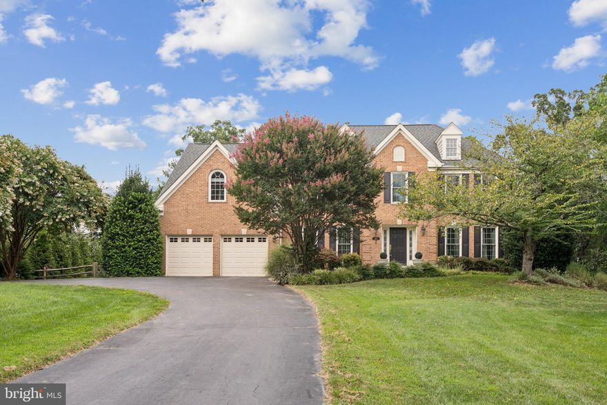 Welcome to this stately brick colonial, set on the largest and most secluded lot in Dufief Mill Estates; over half an acre of lush, landscaped grounds in the heart of North Potomac. From the moment you pull up the long, almost-hidden driveway (with space for 8–10 cars) to the flagstone walkway and classic brick façade, this home makes a grand first impression.

Inside, timeless architecture meets modern luxury. The dramatic two-story foyer opens to formal living and dining rooms, a sunroom, and a main-level office. Rich hardwood floors, custom millwork, and abundant natural light set the tone. The formal dining room connects seamlessly to a butler’s pantry and the gourmet chef’s kitchen, complete with an oversized island, Viking gas range, premium stainless-steel appliances, generous cabinetry, and an adjoining breakfast area. From here, glass doors invite you out to the expansive deck, creating an easy indoor-outdoor flow for both daily living and entertaining. A thoughtfully designed laundry room, with extra storage and a convenient pet door, complete the main level.

Upstairs, the expansive primary suite is a private sanctuary with vaulted ceilings, two custom walk-in closets that feel more like boutiques, and a spa-inspired bath featuring heated floors, dual vanities, a soaking tub,  separate shower, and a private water closet. Three additional bedrooms offer exceptional space,  including a whimsical, custom-built “princess room” with built-ins and a dedicated vanity,  plus two additional full baths.

The walk-out lower level is equally impressive, offering a versatile recreation area, a home gym, a built-in bar,  full bathroom, and a massive storage room that could make any Costco enthusiast swoon.

Step outside to your backyard oasis, an expansive deck stretching the length of the home, a covered gazebo, and a landscaped, fully fenced, tree-lined lawn with an underground sprinkler system. Whether you envision elegant entertaining or relaxed weekends that feel like a Jimmy Buffett song, this outdoor space delivers.

With its unmatched lot, thoughtful upgrades, and move-in-ready condition, this residence offers a rare combination of privacy, luxury, and convenience in one of the area’s most sought-after communities.