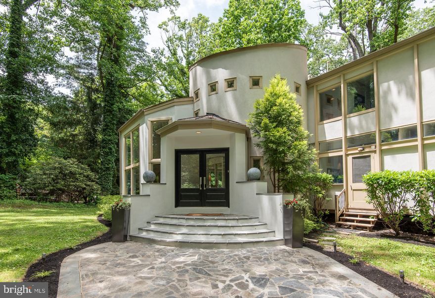 Welcome to our home with lush and plush wooded surroundings.  Wind through the woods up to this expanded, 6500 SF mid-century modern retreat where every room is a room with a view.Step through your double entry doors and the drama begins with a grand, 2-story foyer, open staircase, and free-flowing first floor.  To your left, a vaulted step-down living room with 25  ceilings features full-height windows which frame your nearly 2-acre woodland and open to a flagstone terrace for pre-dinner hors d'oeuvres. Then step up into your lovely, raised formal dining room for the main course. Retire next into your sleek and uber- functional, open-concept kitchen with a spacious family room, where you can continue to drink in nature in every season.   Plenty of counter space, a large pantry, high-end appliances, including grill-top, counter seating for four, and a breakfast area overlooking the blue jays, make for a happy buzz in the kitchen.  If it's cool outside, get cozy in the family room, with its raised, wood-burning fireplace and beamed ceilings, as you watch the leaves change color. Or step out to the lovely deck for al fresco dining and outdoor fun just down the steps onto a patio.  A powder room and convenient mud/laundry room with washer and dryer, folding table and outside entrance complete the main living area. In the master bedroom suite -- centerpiece of the private, four-bedroom first floor sleeping wing -- you open your eyes to the treetops each morning, then move over to your large walk-in closet with built-ins and to your master bath with shower, a jetted tub, glass-walled, enclosed shower and private WC.  There are three more nice-sized, bright bedrooms and a hall bath with shower and jetted tub.Greeting you on the upper level is a charming landing nook currently used as a library.  The adjoining lofted bedroom features dramatic views of the living room and its glass walls and outdoor majesty.  With a sweet window seat, this area could also be used as an office, yoga or meditation space.  A second large bedroom on this level has private access to the hall bath, with new glass-surrounded shower, and can serve as a lovely second-level master suite option.On the lower level is an entertainer's dream:  an elegant, richly-designed private club room, complete with wet bar, game table and pool table area, where you can serve up some craft brews to friends. There s a full bath/mud room on this level, a bright, glass-walled area for a playroom, Peloton room or lounge, as well as an additional living area -- again, with glass walls -- where you can let your imagination run wild.  There's the potential on this level to add a lower-level fireplace.  And there's also indoor access to the bright, oversized two-car garage.  Three zone heat/cooling and loads of closet and storage space help you make efficient use of every level of this bright, open and stylish house.  A unique property for the discriminating buyer.Outside, natural stone walls, idyllic sitting areas, and footpaths grace the very lush property, which features parking for up to 15 cars, as well as turn-around space.  It s almost impossible to believe that this fully private mountain retreat is located in exceptional Lower Merion Township, with its award-winning public and private schools.  With near-instant access to the Schuylkill Expressway, Pennsylvania Turnpike and regional rails, you're but 15 to 20 minutes away from all points, including Center City Philadelphia,  Philadelphia International Airport, and King of Prussia. Bring your dreams. You ll never want to leave.