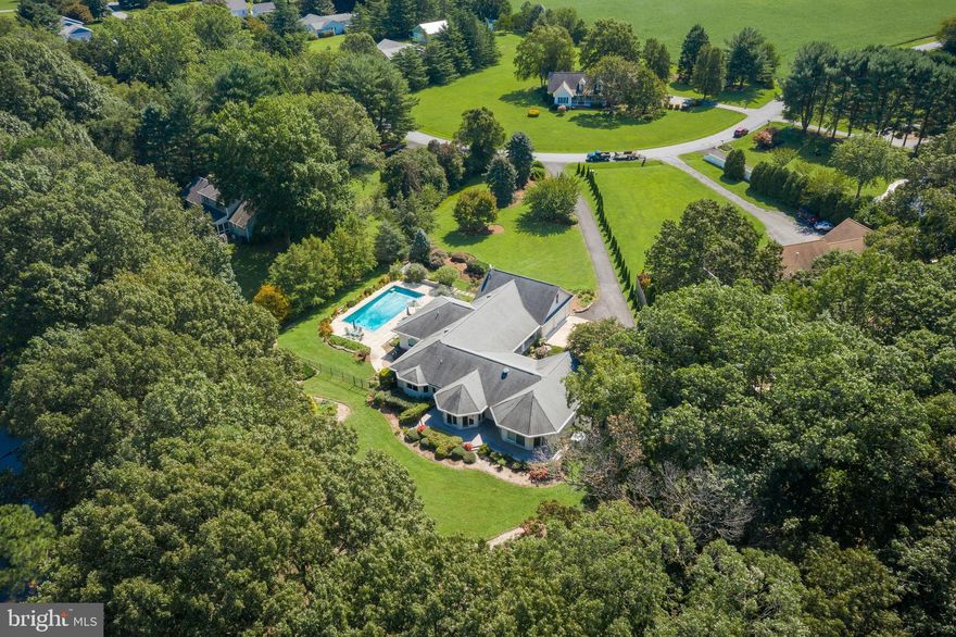 Wye River waterfront! 180 degree northwesterly views! This sprawling Hickory Point property is tucked away on its own private 1.68 acre point of land on the iconic Wye River. Queenstown was founded in 1707, and has been known for all these years as “The Little Town on the Water.” 
This quaint historic town has found the heart of many, and has inspired homes like this one! Custom built in 2004 by Jim Andres,  this deceptively spacious home sits on a private tree lined lot. On your drive along the asphalt paved drive you’ll begin to see the artistry of the gardens, plentiful parking and an invitation to enjoy this special property.
Upon entering the home and step onto the Arctic Maple flooring, you’ll immediately see the glistening of the Wye River through the wall of Anderson windows on the back of the home. Enjoy the 3-sided LP gas fireplace while simultaneously taking in the views. An easy and exceptional home for entertaining. The Foyer, Sunroom, Living Room, Dining and Kitchen create opportunities to host the masses indoors with a layout that includes multiple seating areas. The kitchen offers beautiful maple cabinets with the convenience of pull-out shelves, Silestone countertops, 5 burner gas cooktop, 2 GE wall ovens, stainless, disposal, reverse osmosis and much more. Step outside to through one of the many sliding glass doors onto the expansive deck and take in all that the shore has to offer. Eagles, Osprey, and the Wye River are just the beginning of your entertainment outside. Your private pier, and 2+ MLW offer great opportunities for boating, kayaking, paddle boarding, fishing, birdwatching. Utilize the 4-point boat lift or one of the many local boat marinas to fulfill your boat storing needs. Follow up with a dip in your built in Gunite, Salt water 20’ by 40’ dream pool. The pool includes walk in steps to the 3’ foot and graduates to an 8’ depth. Updates include a CoverStar retractable pool cover 2019, new cover pump 2021,pool pump 2020 as well as a Lurolock winter cover 2019. Illuminated but exterior and underwater light, you’ll enjoy this amenity morning noon and night! Fenced for safety, maintained by Aqua Pools, both for your piece of mind. As the sun sets, and the fireside dinner is finished you will feel spoiled to spend the night in one of the 3 full suites including an exceptional primary suite fully designed to enjoy the water and garden views to its fullest! One level living at its best as all 3 suite presents as an entity of its own. Each offer generous space for sleeping, sitting, reading, writing, and exercise as well housing customized walk-in closets and beautiful views.
While this may seem to be all you need to say “yes” to this home, the beauty doesn’t stop there….Custom blinds throughout, 36” solid core doors, double hung tilt wash windows, insulated interior walls, private home office, fully renovated and insulated crawl space, and so much more! Conveniently located near to all sorts of shopping, restaurants, golf and more!