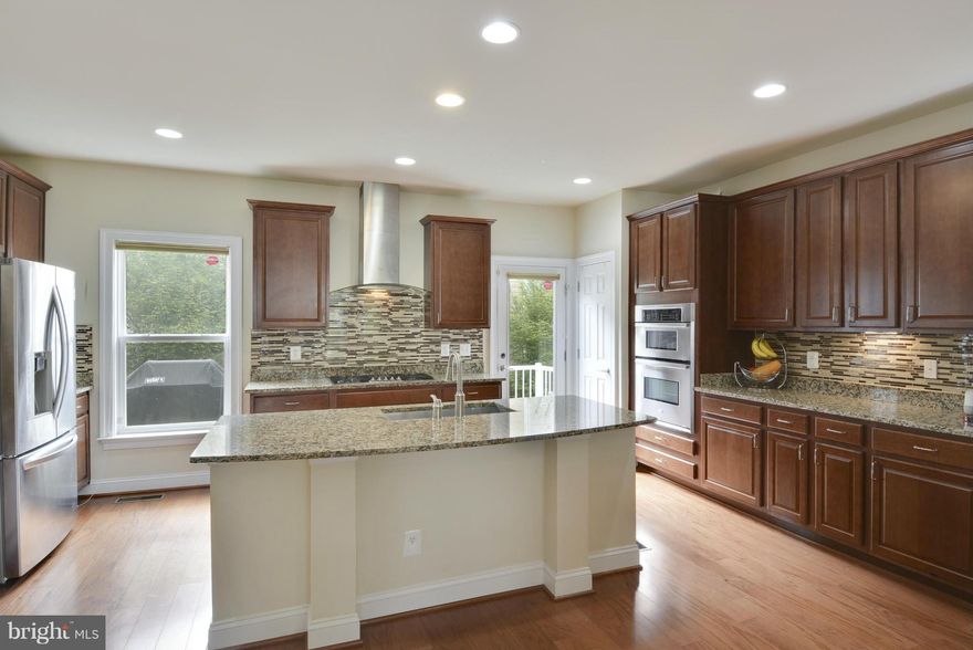 This FANTASTIC turn-key home features 3 bedrooms w/2 full & 2 half baths, two car garage, wood flooring on the main & upper levels, a beautiful gourmet kitchen w/granite counters & stainless steel appliances. Located AT THE VIENNA METRO! Wonderful for commuting. Close to shopping and restaurants. EXTRA PARKING IN FRONT OF THE HOME. Lots of storage and much, much more! A MUST SEE!