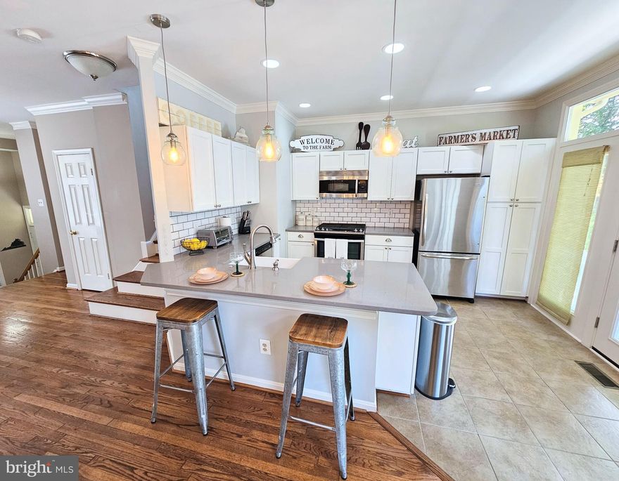 Location, location, location! Beautifully modernized, bright, 3 level, 2 Bedrooms + Den, 2 Full Bath + 2 Half Bath townhome.  Large windows provide plenty of natural light, well decorated and staged with option to rent fully furnished. Upper level contains 2 Bedrooms Suites with own full bathroom each. Primary Bath includes double sinks, a walk-in shower and a separate spa-like tub. Main level has open floor plan with beautifully updated kitchen in natural grays and greens, a formal dining space and a Living Room with gas fire-place and 3rd Bath/Powder Room. Wall-mounted TV above the fireplace is included.  Lower level has two all-purpose Family lounge area and Den with a small window - which can also be utilized for a variety of purposes. Both upper and main floors have beautiful hardwood flooring  - easy to maintain. Lower level was recently redone with light gray LVP flooring. 4th half bath conveniently located on lower level along with separate laundry space with full size Washer & Dryer and entrance to 1 car garage. 2nd car can be conveniently parked in the driveway as visitors spaces are limited in quantity. Visitors may find additional parking in many of the lots provided through out Occoquan city.  The home is surrounded by nature, trees, birds and can be enjoyed on from the deck in the rear or wrap-around porch in front of the home. Occoquan is a historical hidden gem, frequently visited by the tourists looking to get away from the hustle and bustle of the city.   Walk to restaurants, water-front, shops, historical buildings/museums, River Mill Park and a short drive to Regional Parks. Commuter friendly w/ VRE Woodbridge Train Station 2 mi, Bus stop less than 1 mi and 3 Commuter lots within 15 minute drive! Lease term 12 months +. Furnished option available at @2,800/mo. Tenant pays utilities: gas, electric, water & internet. Move-in ready!