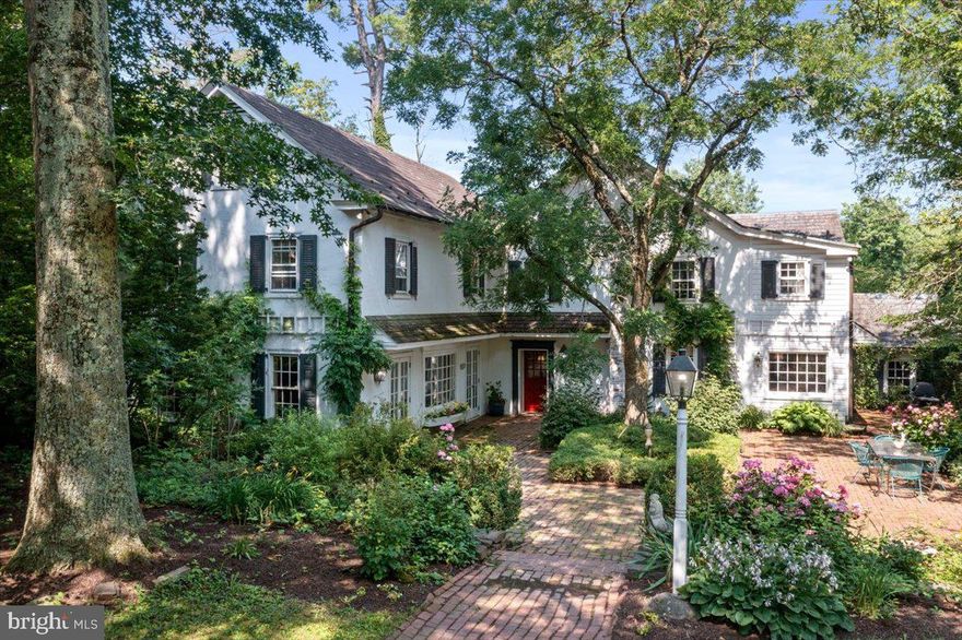 Sitting in a rural corner of country seclusion and hidden from the outside world is Lilliput Farm, a 42-acre property with rich American provenance. Once the country estate of the Lewis family, a family with political heritage, Mr. Lewis was Secretary of Transportation in the Reagan administration and the family hosted President Reagan for a pheasant shoot. Surrounded by similar larger properties and antique homes, the pastoral views of rolling hills and farmland will touch the heart. Enter this enchanted setting via the meandering paved entry drive which crosses a charming bridge between two large, aerated ponds with large-mouth bass. A canopy of mature trees shades the main house, which is surrounded by English gardens and lush landscaping and is centered on an expansive courtyard made of antique bricks from the streets of Philadelphia. Dating to c.1790 with c.1986 additions, the rooms are sizable, and beautiful random width white pine floors run throughout. Designed for entertaining, the entry foyer with powder room greets guests, and the floor plan flows to the vast living room with gas fireplace framed by built-ins, large bay window and two sets of French doors opening to the courtyard, plus a kitchenette-bar area ideal for catering. The formal dining room with two floor-to-ceiling bay window alcoves will easily accommodate a large dinner party. The country kitchen offers charm with soapstone counters, custom island and Mercer tile backsplash, laundry room, and mud room with Saltillo tile floor, each room with storage cabinets. Immediately off the kitchen is the morning room with the original walk-in fireplace, offering a quiet spot for respite. Open to the kitchen is the large family room with richly paneled and beamed cathedral ceiling, wood-burning fireplace, bay window framed with built-ins, and a charming Dutch door to the side brick patio overlooking the 50x22 pool, cabana and tennis court. Turned stairs lead to the main bedroom suite with gas fireplace, built-ins, window seats, multiple closets including a walk-in closet, dressing room and en suite with double marble vanity. Another en suite bedroom with capped fireplace and built-ins is down the hall. The back stairs lead to a second landing with storage cabinetry, hall bath, and third bedroom. The charming fourth bedroom with exposed beams is in the finished attic. There is also a finished basement room with large hand-painted mural to honor President Reagan’s visit. The compound includes a 4-bay heated garage with a 2-bedroom, 2.1 bath apartment above, offering a large deck to enjoy the environs. The Schwenkfelder-style bank barn houses a heated office with brick floor, heated tack room with cold water sink, 4-10x12 stalls with exterior Dutch doors, 1-15x12 mare stall, 1-15x8 pony stall, and 2-10x10 stalls. Upstairs is the feed room, blanket room, storeroom, and substantial hay storage. In addition, there is a pen for pigs, stall for goats, and a chicken shed. Four pastures totaling 25 acres are fenced, each with automatic waterer, and two with underground springs feeding a vernal pond. Four run-in sheds. Currently 20 horses are boarded on site. Atop a hill is the 168x112 fenced riding ring with sand grit mix footings and long-distance views to enhance the riding. Utilities include natural gas, Buderus furnace and multiple heat zones, multiple AC zones, whole-house generator, reverse osmosis filter in kitchen. The contiguous 6.7-acre parcel houses 5 Morton metal pole buildings currently leased as storage units. Ready for your inspiration and re-imagination, this property of historic proportion is located an hour from Center City Philadelphia, perfect for full-time residence or weekend country escape! Conservation restrictions apply.