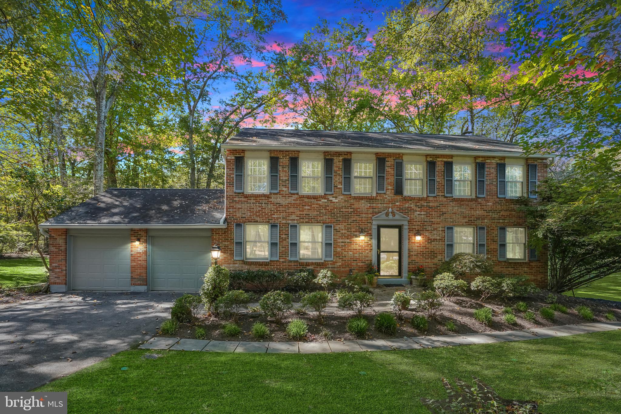 This exquisite colonial home, with a charming brick front, is perfectly nestled on a sprawling 2-acre lot, offering unparalleled privacy and serene wooded views. Inside, the main level shines with rich hardwood floors and intricate accent moldings, leading you through a spacious living room, elegant dining room, and family room highlighting a cozy wood-burning stove surrounded by brick. The kitchen is a chef’s dream, boasting luxurious granite countertops, rich wood cabinetry, and gleaming stainless-steel appliances, complete with a breakfast nook that opens onto an expansive deck, perfect for morning coffee or alfresco dining. For added convenience, there's a main level full bathroom, private office and laundry room with ample storage and easy access to the attached garage. Boasting new carpet throughout, the upper level is home to the tranquil primary suite, which offers a generous walk-in closet with custom built-ins and a lavish en-suite bathroom. Four additional well-appointed bedrooms and a full bathroom complete this level, providing ample space for family or guests. The fully finished lower level is designed for entertainment and versatility, featuring a spacious recreation room, a bonus room, and a large workshop with extensive storage. Step outside to enjoy the serene surroundings on your screened-in porch, set under a soaring cathedral ceiling with skylights, or relax on the expansive open deck, all while taking in the peaceful wooded backdrop and newly landscaped grounds. Additional updates include new garage doors. This home is the perfect blend of luxurious living and nature’s tranquility, a true private retreat.