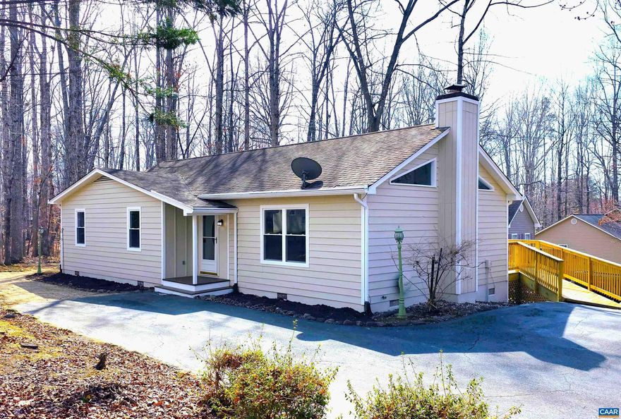 Public OPEN HOUSE SUN MAR 8, 1-3 pm! BEAUTIFULLY RENOVATED ONE LEVEL LIVING HOME in PRIME Lake Monticello location offers 3 BR, 2 Bath home with 1,252 fin sq ft.  Inside, home is THOUGHTFULLY UPDATED for both style & function. IMPROVEMENTS include NEW FLOORING throughout, FRESHLY PAINTED inside & out. RECONFIGURED KITCHEN has expanded space w/ALL-NEW APPLIANCES & CENTER ISLAND W/BREAKFAST BAR. All NEW main-level WINDOWS improve efficiency & comfort. COMPLETELY REMODELED BATHROOMS. CEILING FANS w/integrated lighting added to each bedroom. Living room WOOD STOVE includes a rebuilt exterior chimney box & cleaned flue, offering a practical supplemental heat source. ADD'L FEATURES include LARGE REBUILT SIDE DECK w/direct dining room access & ramp to the driveway, a SPACIOUS PRIMARY BEDROOM w/WALK-IN CLOSET & remodeled ensuite bath, hallway LAUNDRY ALCOVE & LINEN CLOSET.  The FLOORED ATTIC provides plentiful storage. Just two blocks from the Main Gate, Clubhouse, Pools, Main Beach, a Playground, the Marina & Security Office. MOVE-IN READY & ideally positioned to enjoy wide variety of Lake Monticello?s AMENITIES?schedule your showing today!,Quartz Counter,White Cabinets,Fireplace in Living Room