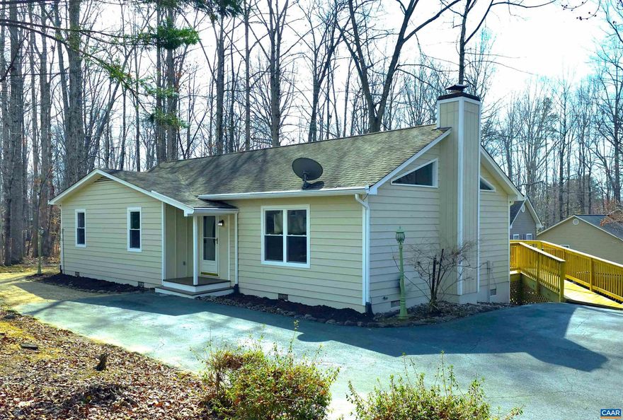 Public OPEN HOUSE SUN MAR 8, 1-3 pm! BEAUTIFULLY RENOVATED ONE LEVEL LIVING HOME in PRIME Lake Monticello location offers 3 BR, 2 Bath home with 1,252 fin sq ft.  Inside, home is THOUGHTFULLY UPDATED for both style & function. IMPROVEMENTS include NEW FLOORING throughout, FRESHLY PAINTED inside & out. RECONFIGURED KITCHEN has expanded space w/ALL-NEW APPLIANCES & CENTER ISLAND W/BREAKFAST BAR. All NEW main-level WINDOWS improve efficiency & comfort. COMPLETELY REMODELED BATHROOMS. CEILING FANS w/integrated lighting added to each bedroom. Living room WOOD STOVE includes a rebuilt exterior chimney box & cleaned flue, offering a practical supplemental heat source. ADD'L FEATURES include LARGE REBUILT SIDE DECK w/direct dining room access & ramp to the driveway, a SPACIOUS PRIMARY BEDROOM w/WALK-IN CLOSET & remodeled ensuite bath, hallway LAUNDRY ALCOVE & LINEN CLOSET.  The FLOORED ATTIC provides plentiful storage. Just two blocks from the Main Gate, Clubhouse, Pools, Main Beach, a Playground, the Marina & Security Office. MOVE-IN READY & ideally positioned to enjoy wide variety of Lake Monticello?s AMENITIES?schedule your showing today!,Quartz Counter,White Cabinets,Fireplace in Living Room