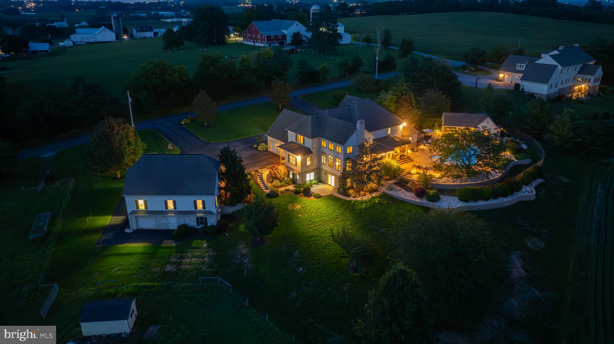 Welcome to 1409 Diamond Station Road! This exquisite custom built home has incredible scenic views of Lancaster County farmland! This expansive 13.42 acre property features a custom home with over 8,300 SF of living space, 5 large bedrooms, 5 full bathrooms and 2 half baths throughout the home. Large detached 3 car garage with attic storage and basement storage, pasture area for animals, and tillable farmland (currently rented). This remarkable home features a primary suite conveniently located on the first floor with full bathroom, two vanities with granite tops, soaking tub, tile shower, large walk in closet, and tray ceiling. A two story foyer welcomes you into the home with one of two staircases to the second floor. Adjacent to the foyer is a large formal dining room for entertaining and large living room/potential office in the front. The full kitchen features granite countertops, large island with barstools for seating, all the extra appliances, full walk-in pantry, space for a large table for 8+ people and more. From the kitchen you move to a cozy sunroom and open patio for your morning coffee overlooking an incredible view of Lancaster County farmland and private pool. Following the kitchen takes you to the family room features 2 story ceilings, gas fireplace and second staircase. From the family room there is a half bathroom, large laundry room with extra storage areas, craft room or potential office/playroom, and attached 2 car garage. On the second floor, you’ll find 4 large bedrooms with 3 private bathrooms and attic storage available. The lower level of this custom home boasts over 2,600 SF of living space! It features a full in-home theatre room, living room with wood fireplace, kitchen area, full bathroom, extra playroom, storage area, patio, and extra office/bedroom with outside entrance. The back of the sunroom/patio overlooks a large entertainers paradise with a pool area that features an expansive patio for guests, large sparkling pool for parties, pool house complete with kitchen, changing rooms, and half bath. 1409 Diamond Station Rd has a country feel but only a few minute drive to Rt. 272 and Rt. 222 for easy access to downtown Lancaster and about 50 mins to King of Prussia. Properties like this don’t come around often so don’t miss this opportunity like this! Call to schedule your private tour today!