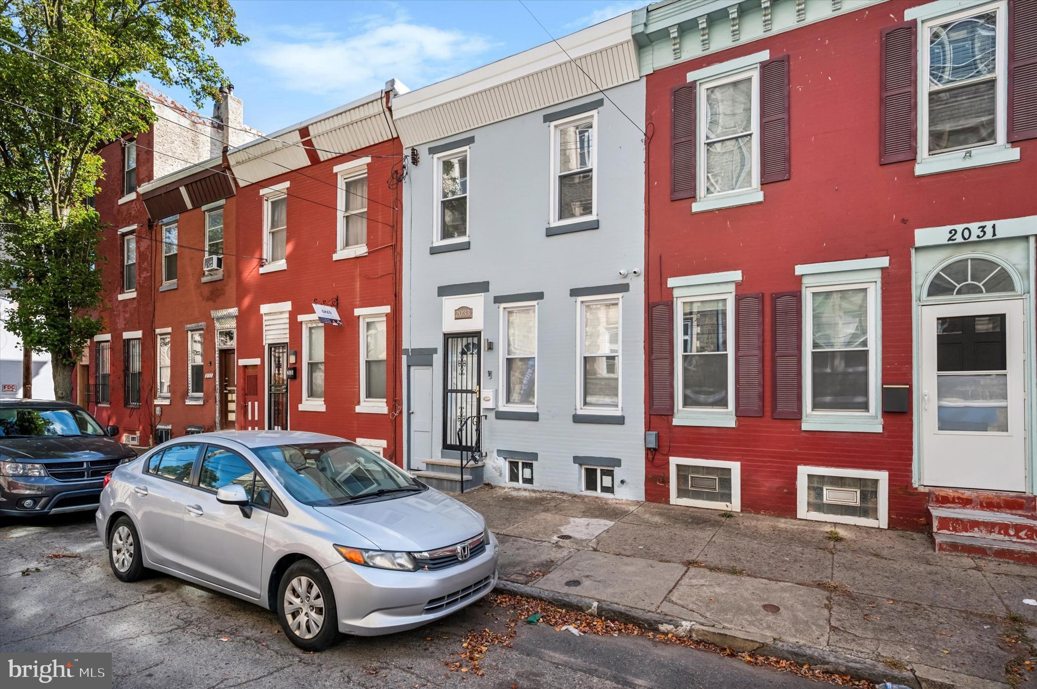 Welcome to 2033 N Mascher Street, a stunning fully renovated 2-bedroom, 1-bath townhome nestled in the heart of the vibrant Norris Square neighborhood of Philadelphia. This home exudes modern elegance with a perfect blend of contemporary finishes and timeless charm. Step inside to an open floor plan that’s ideal for both daily living and entertaining. The living room boasts a sleek electric fireplace, creating a cozy ambiance, while gleaming hardwood floors and ceiling fans enhance the comfort and style throughout the home. The combined living and dining area seamlessly connects to the well-appointed kitchen, featuring stainless steel appliances, a chic white subway tile backsplash, and counter space, perfect for culinary enthusiasts. The private, fenced-in rear yard is your personal retreat, providing a serene space to relax, entertain, or simply enjoy the outdoors. Upstairs, you'll find two good sized bedrooms, each offering generous closet space with built-in shelves for convenient storage. The modernized full bath adds a touch of luxury with updated fixtures and finishesThe partially finished basement offers a dedicated laundry area with a washer and dryer, along with concrete flooring, providing a versatile space that can be used for storage or easily transformed into a home office, workout area, media room, and more. This home comes equipped with a video surveillance system and a Ring camera for added peace of mind. Situated just steps from Norris Square Park, you'll enjoy easy access to green spaces, popular restaurants, shopping, and public transportation, making city living as convenient as it is exciting.