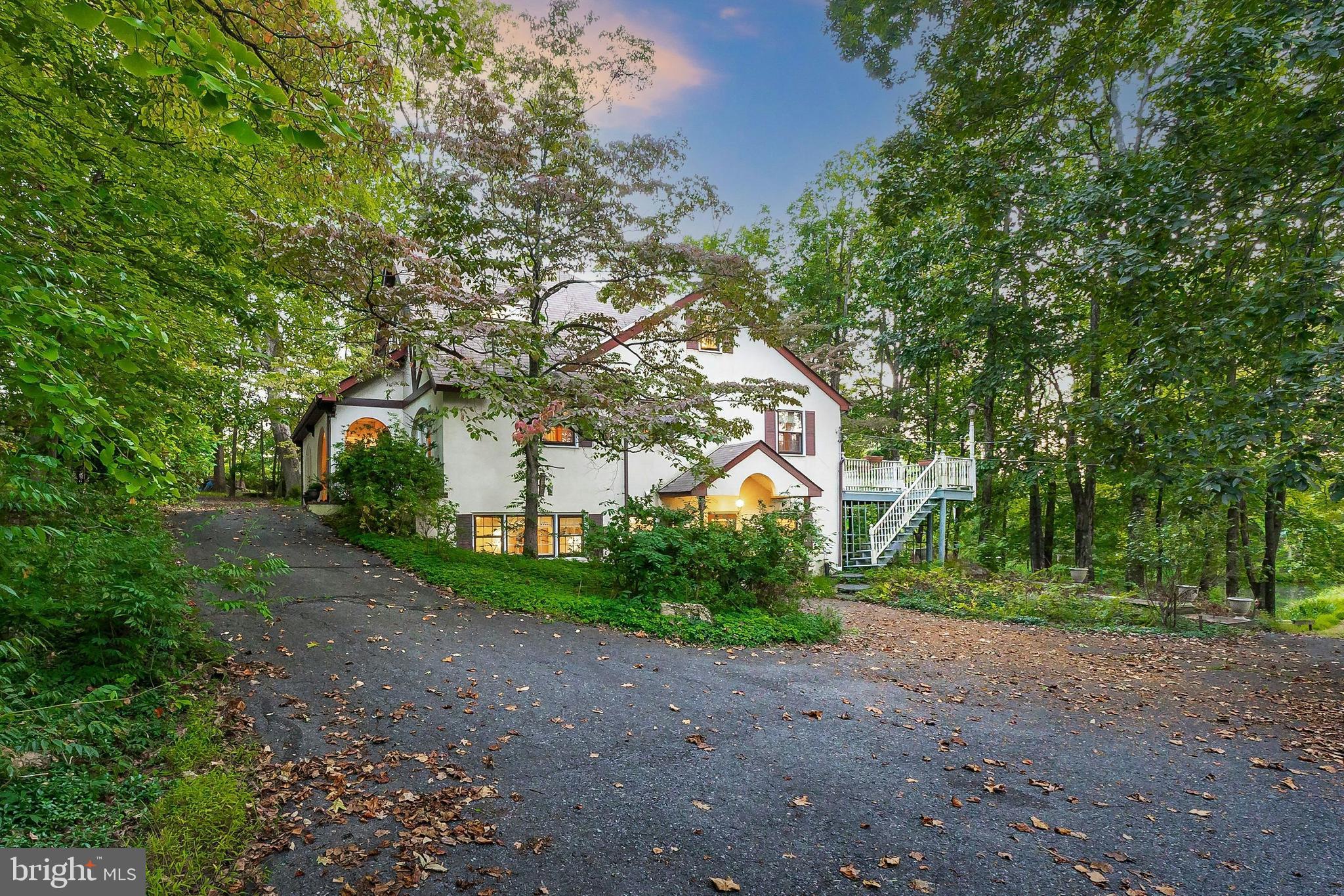 Twin Pond Villa Tucked away on over five private acres in Lower Saucon Township, this remarkable property offers a rare combination of natural beauty, historic character, and modern comfort. The home balances mid-century charm with flexible spaces for today’s living, surrounded by water, mature trees, and timeless tranquility. The unique setting features two spring-fed ponds connected by a charming bridge. Adding to the storybook feel is a historic ice house, a nod to the region’s agrarian past and a distinctive historic building type that few properties can claim. Inside, the residence offers more than 3,200 square feet over three finished floors, with a layout that allows for both privacy and connection. The flexible upper level allows for bedrooms, offices, or creative studios, making it ideal for a variety of lifestyles. A fully finished walkout lower level with second kitchen offers the potential for updates. With ample space for gardening, recreation, and outdoor entertaining, the property has two separate parcels. For those with an eye for design, this is a rare chance to craft a dream home on an extraordinary piece of land, with room for gardens, recreation, and outdoor entertaining. A true sanctuary, the property blends privacy and potential in a premier location, just minutes from town conveniences.