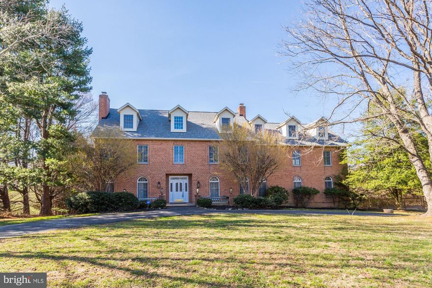 Entertain with ease in this exquisite all-brick Colonial, boasting close to 8,000 square feet of exceptional formal living space with no expense spared.  All at the end of a prime Highland cul-de-sac. Step inside the soaring two-story foyer with exquisite chandelier, an elegant entry that leads to the formal spaces including the well-sized dining room with butler’s pantry, and the living room with a brick profile wood burning fireplace. Glistening hardwood floors extend throughout and tall 9' ceilings and 8' doors will elevate your eye. Opposing formals perfect for celebratory dinners with family and friends highlighting sunbathed oversized windows, crown molding, chair railing, and gorgeous hardwood flooring. Just through the entryway, you’ll find the well-planned kitchen and breakfast area. The gourmet kitchen offers brand new granite countertops, stainless appliances, spacious cabinetry, wall oven, cooktop, massive coffee bar, and huge island with breakfast bar around which loved ones are sure to gather. Not to mention the oversized stainless steel sink and prep sink in the island. A chef's dream kitchen! Travel into the impressive family room complemented with floor to ceiling windows, and another brick profile wood burning fireplace. French doors lead you into the quiet library with huge built in shelving and desk, perfect for anyone who works from home and just wants a peaceful place to sit back and read a book or finish up last minute work. Through the French doors lining the backside of the house is the private back yard and full-width back deck with inviting covered porch - an ideal spot for an outdoor dining and living areas. A powder room completes the masterfully designed main level. The well-sized second level primary suite includes double walk-in closets, and a spacious primary bath complete with water closet, soaking tub, and huge wrap around vanity. The upper level also features three additional spacious bedrooms, each with and attached bath adjacent and an ample or walk-in closet. In the second level foyer you will find a gorgeous spiral staircase leading to a huge recreation room in the attic which includes a large unfinished storage area and a full bathroom. Make it a music room, play room, or hang out spot, whatever you can imagine can be done! The huge lower level offers ample well sized areas which make finding extra space for storage a breeze. With a car side-entry garage connected to the lower level and long private driveway, you’ll have more than enough parking for all of your vehicles. This home was designed to entertain and is sure to captivate any guest. A beautiful home in a picturesque location.
