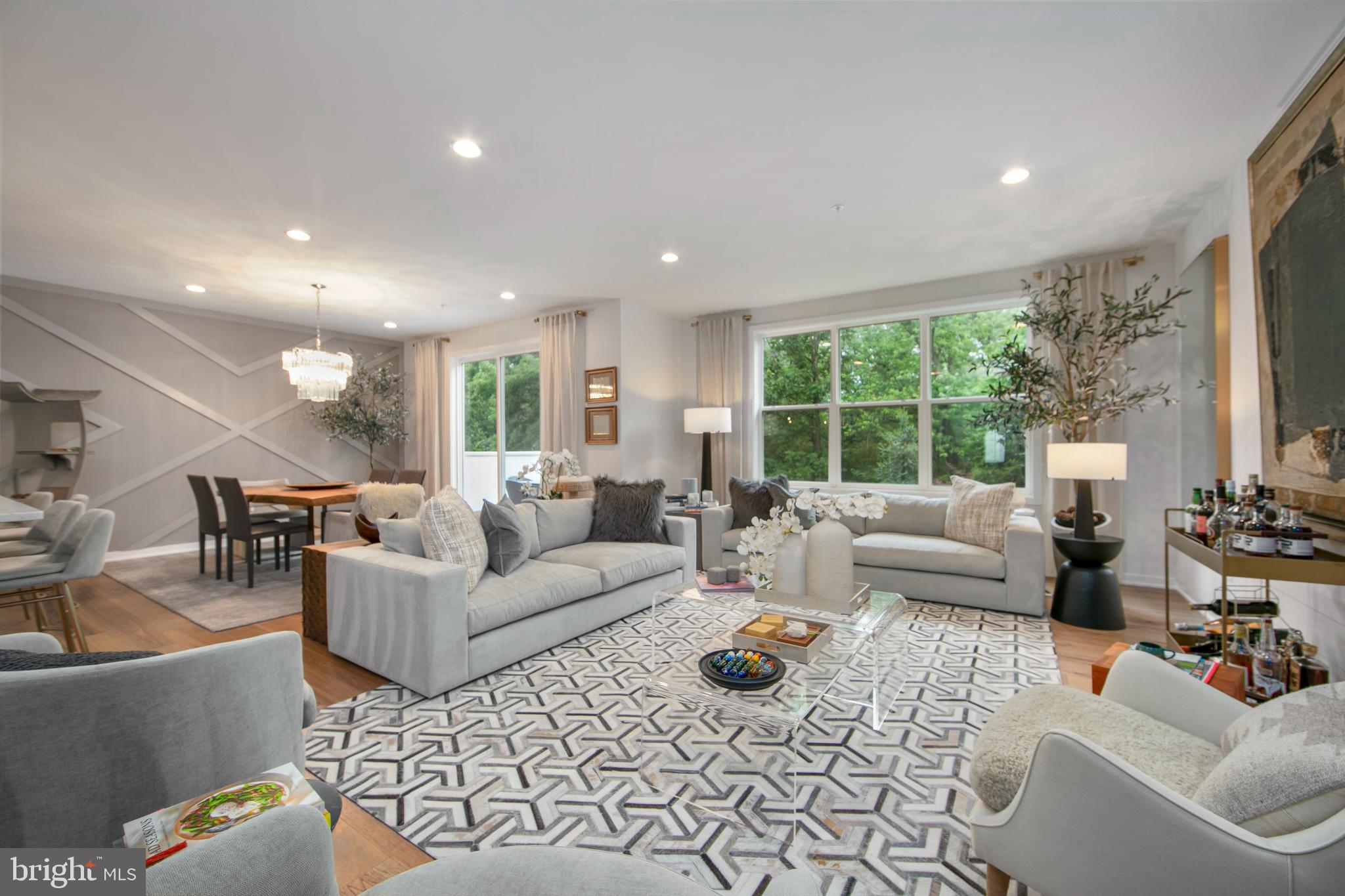 Luxury Toll Brothers Townhome – Premium Upgrades Throughout. Set on a fully landscaped lot in the award-winning Central Bucks School District, this 3-bedroom, 3.5-bath home features a fully finished basement and interior designer curated finishes.Flooded with natural light enter a two-story foyer and immediately notice the refined atmosphere with 3 Herman Miller Pendant Lamps. Large windows create a sunlit great room- kitchen, living, and dining areas with high ceilings, custom feature walls and an expanded chef’s kitchen outfitted with a marble backsplash, upgraded cabinetry, under cabinet lights and premium appliances. Large sliding doors open to a private deck, where you can enjoy peaceful mornings in a meticulously landscaped oasis built for maximum privacy. Powder room fully renovated from builder grade with new vanity, feature tiles, backlit mirror and premium fixtures- a true gem!. Upstairs includes a wood floor throughout. The expansive primary suite boasts a fully finished grand walk-in closet, large spa bathroom with statement tile and modern fixtures. Two additional bedrooms offer custom closets and the updated second bath and laundry room feature high-end finishes and built-ins. Both upstairs bathrooms have upgraded custom shower doors and shower fixtures. A custom library nook adds a touch of sophistication.The fully finished basement provides multiple living areas and a designer full bath, perfect as an additional bedroom or in-law suite.Owners spared no expense! Additional highlights include a two-car garage with epoxy flooring, Lutron dimmers in all rooms for ambiance lighting, automated Hunter Douglas shades, custom Container Store closets, premium designer lighting, and an underground sprinkler system. Every detail was curated by a professional interior design firm.