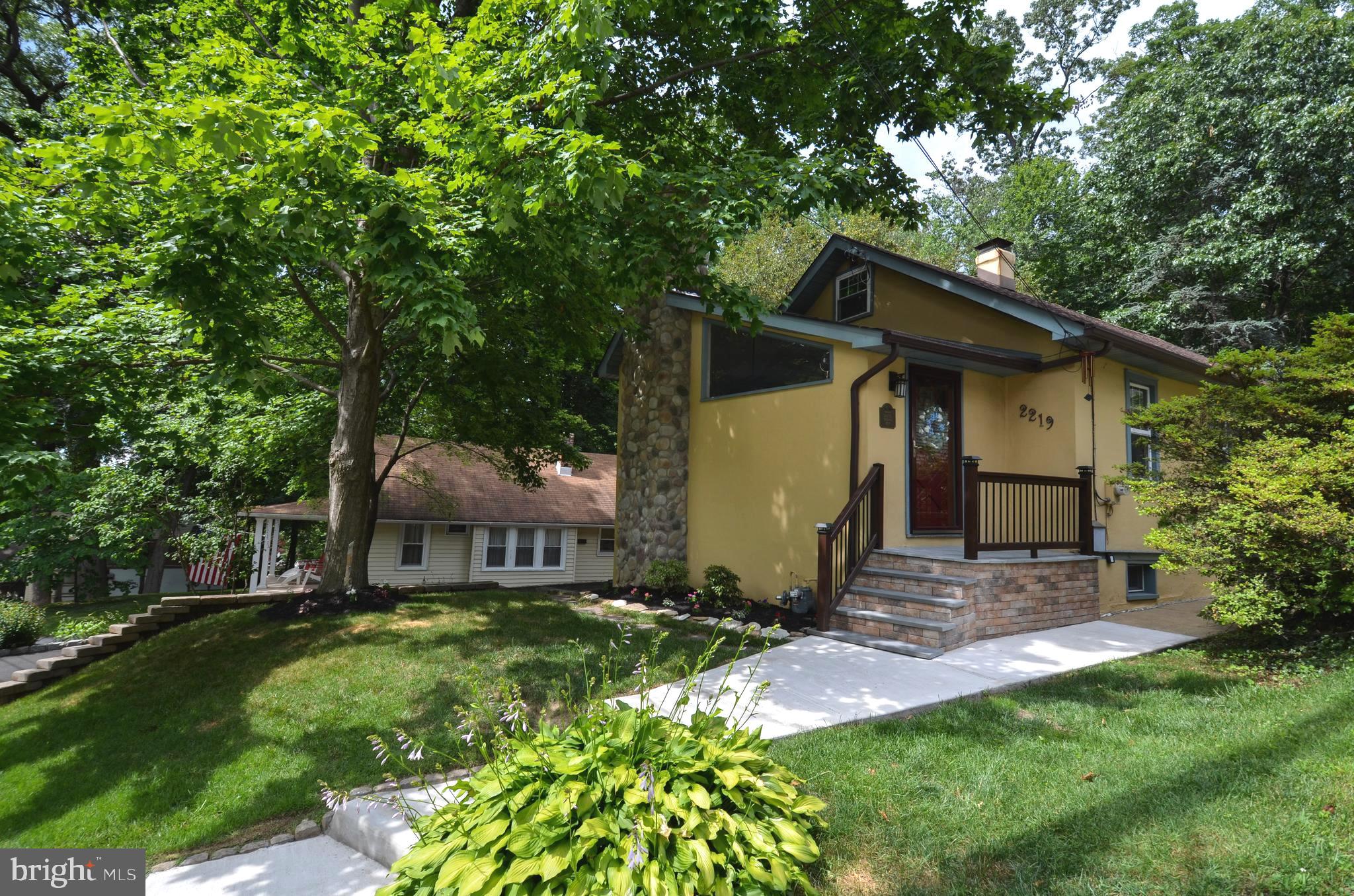 Come visit this beautiful, charming, well-kept home in award winning Abington School District.  Brand new stone work on the front landing gives a fresh curb appeal. Enter through the expansive living room with vaulted ceilings, skylights, newly refinished hardwood floors and real fireplace with a towering mantel.  Off to the side you'll find an area perfect for a desk, reading nook, or dining room. Enter the kitchen, plenty of space for entertaining.  Tasteful color choices add to the charm of the kitchen.  Notice the beautiful backsplash, all hand painted imported tile, throughout.  Newer stainless steel appliances and natural gas stove.  Kitchen opens up into a very private, charming fenced in backyard.  Property connects with Briar Bush Nature Center and Bird Sanctuary, perfect for morning walks and offers the peace and serenity only found in a property like this.  Nice, clean brick and stone patio leads through the gate down the steps to the extended driveway with an attached garage.  Finished basement includes plenty of closet space and a separate utility area with washer, dryer and utility sink.  Finally, find some peace and quiet on the second floor in the Master Suite, complete with full bath and windows with the calming view of the surrounding foliage.  Truly the perfect environment for a restful sleep and cozy nights spent inside.  This place is move in ready, don't miss!