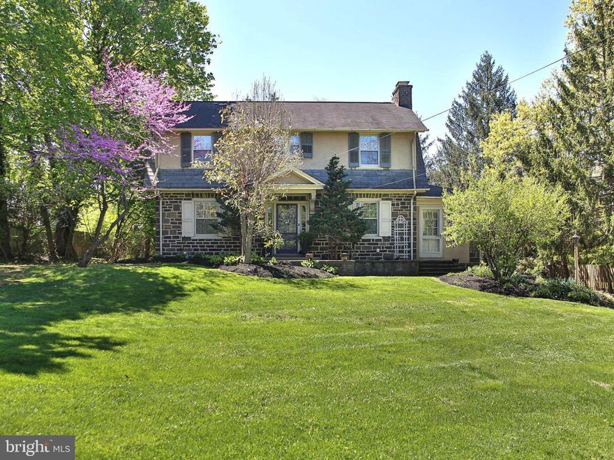 Set on a beautifully landscaped .45-acre lot in the prestigious Upper Gwynedd Township, this distinguished 3-bedroom, 2 full bath residence seamlessly blends timeless elegance with refined modern living. A striking stone exterior and manicured tree-lined grounds create a captivating first impression. Enhanced by lush plantings and seasonal blooms. A picturesque walkway framed by stone retaining walls, steps, leads you to the inviting front entry. The expansive grounds offer a private, serene setting—perfect for outdoor entertaining or quiet enjoyment. Inside, a welcoming foyer introduces the home’s classic sophistication, featuring rich hardwood floors, detailed millwork, and a beautifully crafted staircase. The formal dining room exudes elegance with refined wainscoting, designer finishes, and a statement chandelier, creating an ideal backdrop for both intimate gatherings and formal entertaining. At the heart of the home, the inviting family room is anchored by a stunning stone woodburning fireplace and enhanced by abundant natural light and custom built-ins. This space offers a seamless flow, ideal for both relaxed living and hosting guests. The kitchen offers a bright and classic appeal with modern updates, including a newly installed double-wall oven, sleek induction glass cooktop, ample cabinetry, generous counter space, and a stainless-steel refrigerator provide both functionality and style.  A versatile living space, currently utilized as a private home office, showcases an exposed stone wall and a wall of windows that flood the room with light. This distinctive space offers flexibility as a study, sitting room, or additional living area. A full bath on the main level adds convenience, while a rear mudroom provides a well-appointed transition space with direct access to the outdoor entertaining area. The upper level offers brand new plush carpeting throughout.  The spacious primary bedroom offers a peaceful retreat with soft tones, generous in size, it features both a walk-in closet and an additional closet, providing exceptional storage and functionality. Two additional bedrooms provide comfortable accommodations, each thoughtfully designed with ample closet space and bright, airy interiors. A full hall bathroom serves this level with classic finishes.  Outdoor living is elevated by a beautifully designed stone patio, ideal for dining al fresco or entertaining in a private setting. Surrounded by mature landscaping and enclosed by an elegant wrought iron fence, the space offers both charm and seclusion. A detached 2-car garage and expansive driveway provide ample parking and storage. Completing the home, the unfinished basement includes a dedicated laundry area and abundant storage potential. A rare offering that combines classic architecture, thoughtful updates, and an exceptional setting. This home delivers a lifestyle of comfort, elegance, and convenience. Ideally located just minutes from major routes, shopping, and a variety of popular restaurants, this home offers both convenience and connectivity. Upper Gwynedd Township is known for its beautifully maintained parks, walking trails, open space, and strong sense of community, along with easy access to nearby towns, commuter routes, and everyday amenities. This exceptional property presents a rare opportunity to enjoy refined living in one of Montgomery County’s most desirable locations.