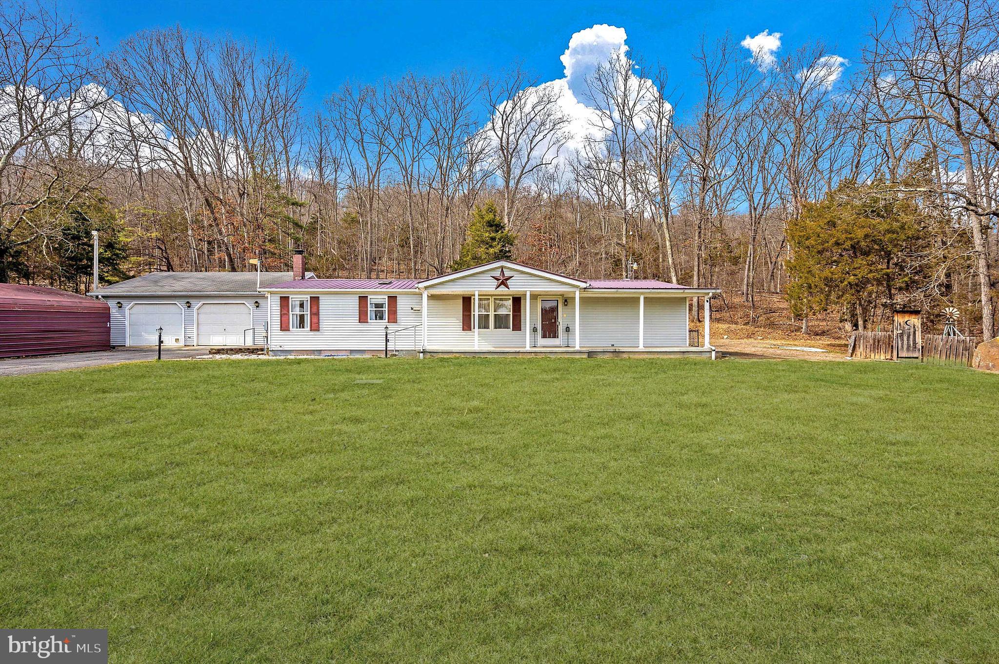 Welcome home to 14622 Hollow Rd, your serene countryside retreat! Step onto the front porch and envision sitting back in a comfortable chair as you sip your morning coffee or unwind with a glass of wine in the evening while gazing out onto OVER HALF AN ACRE of sprawling land. As you step through the front door, imagine kicking off your shoes in the foyer after a long day and immediately being embraced by the inviting warmth of this charming home. The open floorplan is sure to delight! In the dining area, generous windows present stunning nature views, providing a scenic backdrop for every meal. The expansive kitchen boasts endless cabinet and counter space, an island great for food preparation, a convenient bar area, and a cozy breakfast nook. Main-level laundry room! Picture mellow evenings spent curled up on the sofa and enjoying the company of family and friends, your favorite TV show, or a great book in the adjacent, spacious living room. Bask in the abundant natural light and verdant views in the sunroom, an idyllic space for relaxation, a home gym, or cultivating your favorite indoor plants. Surrounded by towering trees, your backyard beckons, providing a private setting for hosting a summer barbecue, creating lasting memories with loved ones, or enjoying a quiet afternoon. Retreat to the sizable owner's suite, featuring ample closet space and an ensuite bathroom with a luxurious soaking tub. Two additional bedrooms and an UPDATED (2023) full bathroom provide convenient accommodations for all. Venture downstairs into the tremendous basement which offers infinite possibilities, whether you need extra storage or wish to create the finished space of your dreams! The oversized garage is complete with heat and electricity, making it a year-round versatile space, perfect for the everyday homeowner, contractor, woodworker, landscaper, car enthusiast, and more! NEW HVAC! NEW Washer, Dryer & Fridge! Close proximity to local markets, restaurants, and I-70. Nature lovers rejoice, only minutes from scenic C&O Canal/Potomac River, biking, hiking, fishing, and the natural hot springs in Berkeley Springs! Your slice of heaven awaits- schedule your showing today!