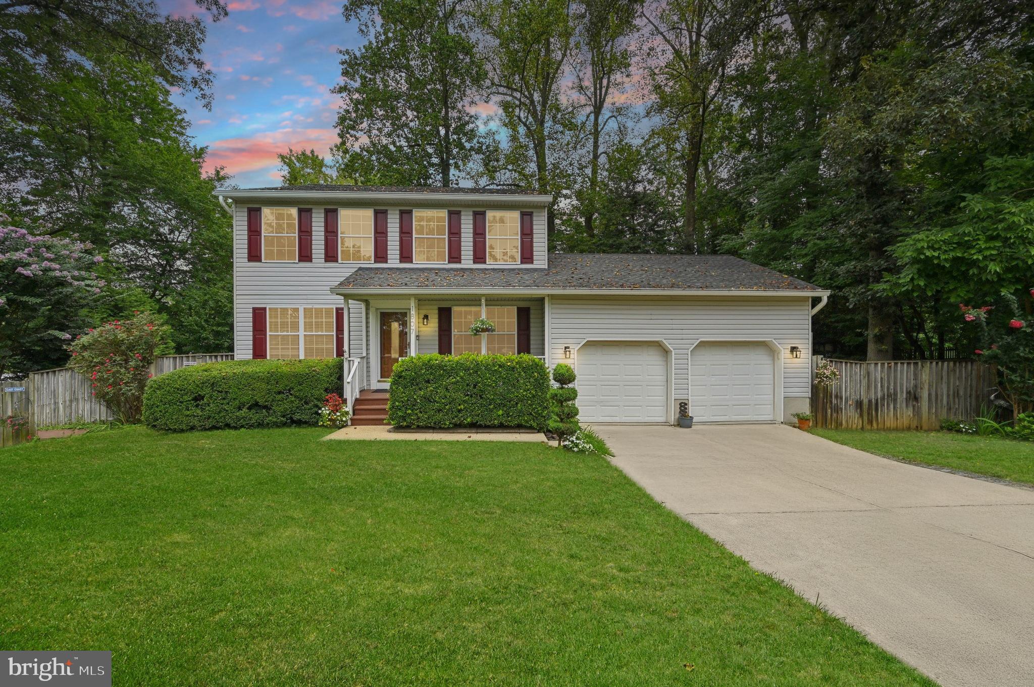 Welcome home to this beautiful property set on a gorgeous lot with mature trees and thoughtfully designed landscaping. A long driveway leads to the inviting front porch and fenced yard with parking made easy. Inside, hardwood floors span the main level, featuring a formal dining and living room, plus a cozy family room with a brick-accented fireplace. The eat-in kitchen offers stainless steel appliances, ample cabinetry, and a custom backsplash. Step outside from the family room to a large deck with stairs leading to the backyard and patio, perfect for outdoor entertaining. Upstairs, you’ll find generously sized bedrooms, including the primary suite with a dual vanity and stand-up shower. The finished basement adds versatility with an additional room and walkout access to the yard and deck. This home offers space, comfort, and charm, both inside and out!