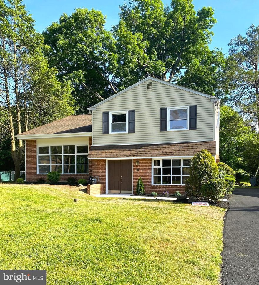 This sunny 4 bedroom, 2.5 bath split level home offers an impressive amount of living space on a verdant lot in Elkins Park.  Newly painted throughout, the home opens to the foyer with coat closet that offers a great space to receive guests.  Immediately, you'll pass the office / den that is smartly separated from living spaces of the home.  At the end of the foyer hall, you'll find a convenient half bath.  From there, go to the right and you'll find a very large living room / bonus room space that can accommodate  a variety of activities.  You'll also have access to the side mud room that leads to the driveway or the larger rear mud room that leads to the backyard.  Both offer an impressive amount of storage.  At the front of the home, you'll find a more formal, large living room that eases into the dining room space, complete with hardwood floors, recessed lights and tons of light.  The eat-in kitchen offers stainless steel appliances, granite counters and lots of cabinet and work space.  Upstairs, you'll find a remodeled hall bath, large hall closet in addition to the primary bedroom, as well as 2 additional bedrooms.  The hardwood floors continue throughout the upper floor, and the primary bedroom offers an en suite bathroom and walk-in closet.  The third floor offers an additional bedroom with brand new carpeting, a walk-in closet and tons of additional storage space.  Central air throughout with exception to bonus room.  The newly paved driveway easily accommodates 4 + cars. New landscaping mixed with mature trees at the back of the property offer a breezy backyard great for enjoying the outdoors. Close to school, shopping, hospitals, 3 minutes to the train, this location offers a convenient location with easy access to Center City and surrounding areas.
