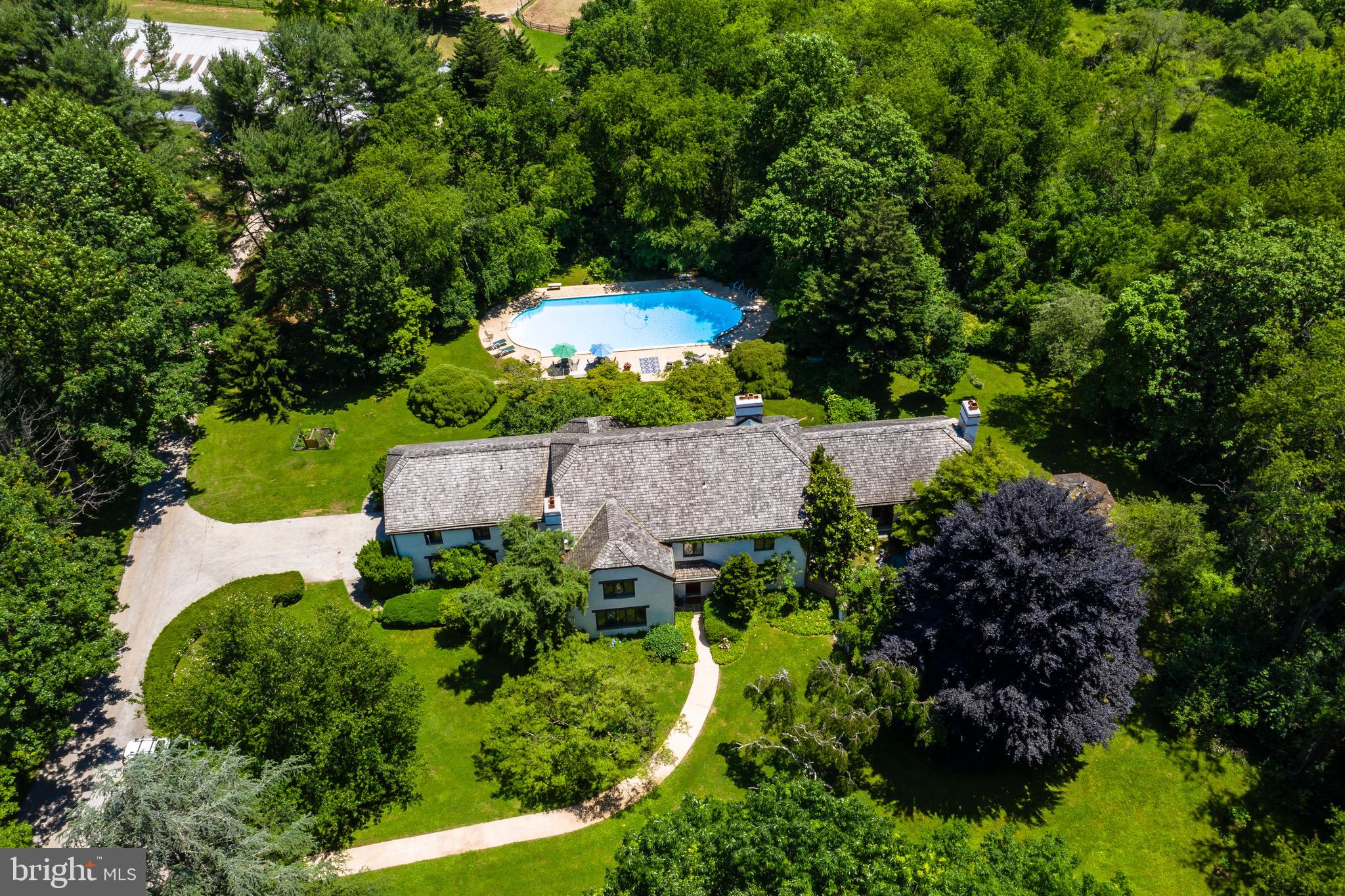 It's your Lucky Day! What an incredibly rare opportunity to become the new owners of this exquisite home for the nature lover & horse enthusiast. The original owners have decided to sell the most spectacular 20.9 acres with an 18-stall horse barn with indoor and outdoor riding rings I've ever seen located in Willistown Township! Welcome home to charming 239 Spring Road! Live in the heart of Radnor Hunt Country bordering historic Sugartown. Proximal to fine dining, local attractions, and popular storefronts, yet tucked away in an expanse of lush lawn, hidden amongst the treetops on 20.9 acres of heavenly pastureland. Custom built to resemble an English Cottage. The definition of curb appeal, this property features a private drive, manicured lawns, seasonal views, lush pastures, 2 car attached garage, plus a detached 3 car garage by the stables, romantic gazebo, potting shed, two serene patios to take in the view, and a luxurious in-ground swimming pool that begs you to dive right in and take a swim. Pristine, white interior features spacious rooms with panoramic views, custom hardwood and slate flooring throughout, an absolutely stunning great room with a vaulted wood beam ceiling, featuring a walled garden off the great room that leads to the gazebo. Library featuring a fireplace and doorway to walled garden, gallery with fireplace that looks out to the patio. The basement has a full bath and large brick floored room with fireplace that leads out to steps to the huge in-ground pool. 6 sophisticated and serene fireplaces, a breakfast room bathed in natural light, and a chef-style kitchen with top-notch appliances to meet all of your culinary needs. First floor offers a laundry room and half bath for convenience. Master bedroom sparks magic with its cozy interior featuring a sitting room and a fireplace that overlooks the patio, two full his and her master baths. 5 additional bedrooms are equally as spacious and can be easily converted to a home gym, yoga studio, or reading room. Each bedroom has plenty of closet space. Beautifully curated with unmatched rustic charm, make 239 Spring Road yours today! A coveted Radnor Hunt location and only minutes to Malvern Borough and downtown Wayne with the convenience of the train to Philadelphia and NYC, excellent restaurants, shopping, Episcopal Academy & Malvern Prep and Westtown School. Don't miss this one of a kind property awaiting the most discerning Buyer. As a bonus, the barn is currently being leased and produces income. Act 319
