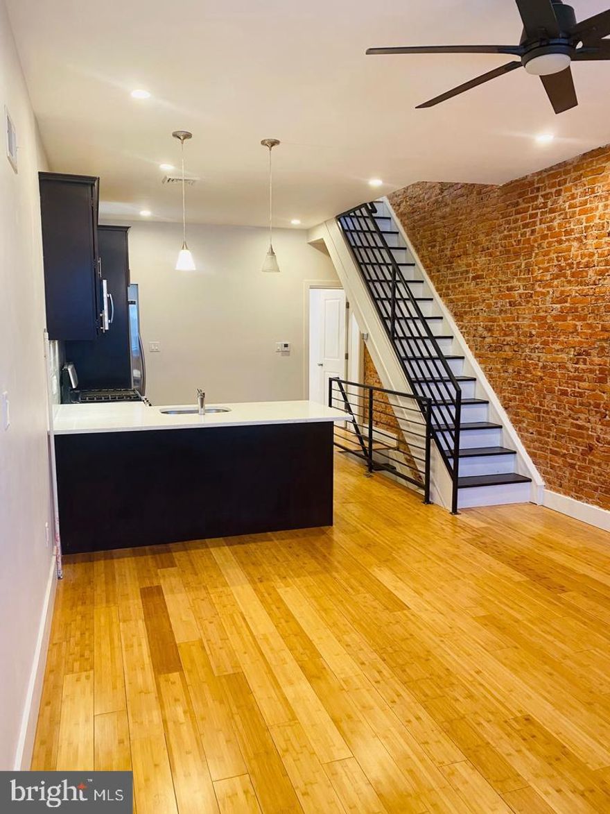 This beautifully updated 4-bedroom, 2-bathroom home seamlessly combines modern convenience with timeless charm. Upon entering, you’ll be greeted by a spacious living area highlighted by stunning exposed brick, adding warmth and character to the space. The open-concept peninsula kitchen is thoughtfully designed with a stainless steel appliance suite, sleek cabinetry, and ample counter space, making it perfect for both cooking and entertaining.

Adjacent to the kitchen, direct access to a private patio provides the perfect setting for outdoor dining, morning coffee, or simply unwinding.

The fully finished basement expands the home’s versatility, offering additional living space along with a dedicated laundry area. This space can be transformed to fit your needs, whether as a home office, gym, or media room.

Upstairs, sunlit bedrooms provide generous storage and a comfortable retreat. Throughout the home, gleaming hardwood floors enhance the aesthetic, while central air ensures comfort in every season.

Don't miss out on this incredible opportunity—schedule your showing today!
