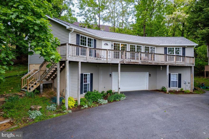 Discover the perfect blend of mountain view, comfort, and elegance close to the Potomac and Shenandoah Rivers in this stunning raised ranch home nestled in the serene Bolivar Village. This meticulously maintained residence, renovated in 2019, boasts 4 spacious bedrooms (or 3 Bedrooms and an awesome Rec Room) and 3 spacious bathrooms, including a primary suite with a soaking tub and walk-in closet. The open floor plan seamlessly connects the gourmet kitchen-equipped with stainless steel appliances and upgraded countertops-to the inviting living and dining areas, enhanced by recessed lighting and hardwood floors. Step outside to your private oasis on a generous 0.52-acre lot, where lush landscaping and mature trees create a tranquil retreat. Enjoy scenic vistas of the surrounding mountains and gardens from your expansive deck off the front of private patio on rear, perfect for entertaining or unwinding after a long day. The property is ideally located near the Potomac River, just 3 miles away, offering endless opportunities for outdoor adventures. With commuter access to all major metro areas of MD and VA, this home is positioned in a prime location to welcome you home after a hard day at the office.  Additional features include a fully finished basement with a workshop, a cozy gas fireplace, and energy-efficient windows throughout. The attached garage provides ample parking, while the private driveway location ensures peace and privacy. There are only 2 houses utilizing Carter Lane.  Bolivar Village is not just a home; it's a lifestyle. With easy access to local amenities and the breathtaking beauty of nearby national parks, this property is a rare find. Experience the perfect balance of nature and modern living-schedule your tour today!