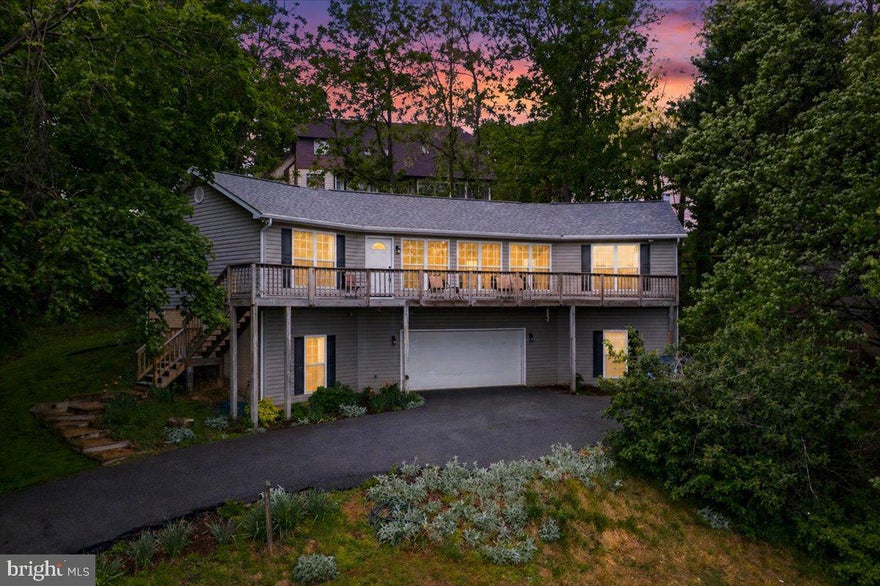 Discover the perfect blend of mountain view, comfort, and elegance close to the Potomac and Shenandoah Rivers in this stunning raised ranch home nestled in the serene Bolivar Village. This meticulously maintained residence, renovated in 2019, boasts 4 spacious bedrooms (or 3 Bedrooms and an awesome Rec Room) and 3 spacious bathrooms, including a primary suite with a soaking tub and walk-in closet. The open floor plan seamlessly connects the gourmet kitchen-equipped with stainless steel appliances and upgraded countertops-to the inviting living and dining areas, enhanced by recessed lighting and hardwood floors. Step outside to your private oasis on a generous 0.52-acre lot, where lush landscaping and mature trees create a tranquil retreat. Enjoy scenic vistas of the surrounding mountains and gardens from your expansive deck off the front of private patio on rear, perfect for entertaining or unwinding after a long day. The property is ideally located near the Potomac River, just 3 miles away, offering endless opportunities for outdoor adventures. With commuter access to all major metro areas of MD and VA, this home is positioned in a prime location to welcome you home after a hard day at the office.  Additional features include a fully finished basement with a workshop, a cozy gas fireplace, and energy-efficient windows throughout. The attached garage provides ample parking, while the private driveway location ensures peace and privacy. There are only 2 houses utilizing Carter Lane.  Bolivar Village is not just a home; it's a lifestyle. With easy access to local amenities and the breathtaking beauty of nearby national parks, this property is a rare find. Experience the perfect balance of nature and modern living-schedule your tour today!