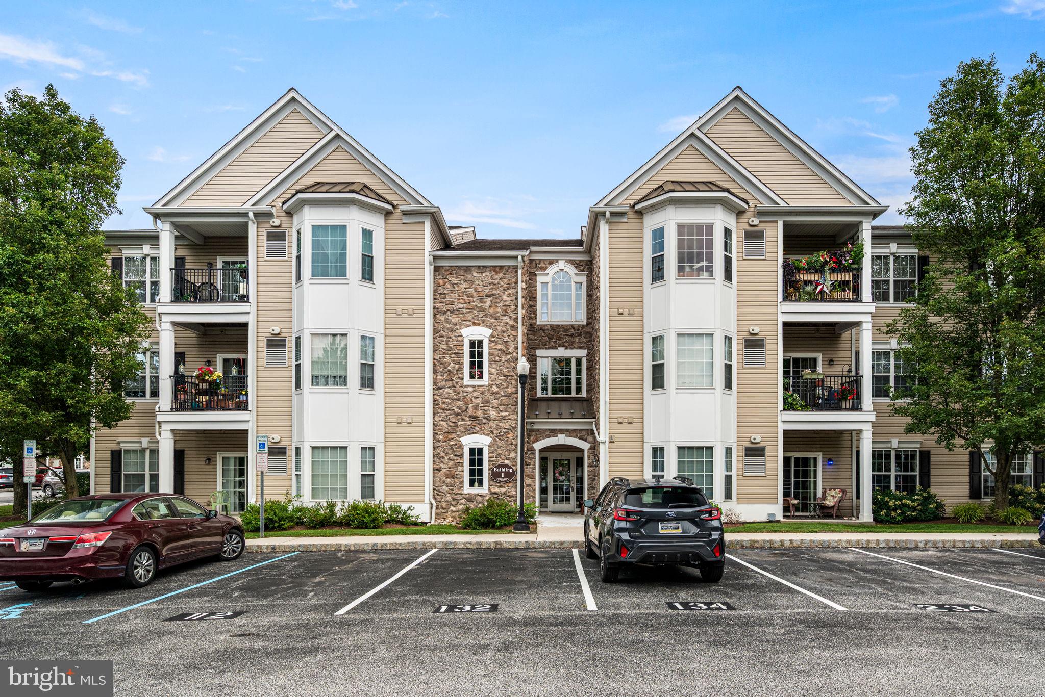 Welcome to care free living at the beautiful 55+ community of traditions at Ridley Creek. The convenience of this unit is unmatched. Right from the parking lot, unit 113 is on the first floor, just a few short steps inside the main entrance. No elevator or steps needed. Walk in through the welcoming foyer and feel right at home. First thing you'll notice upon entry is the open concept feel. Dining, kitchen and living room all flow perfectly into each other. Beautiful hardwood floors from the front door through to the kitchen. U-shape kitchen with an abundance of storage and countertop space. The living room is right in the heart of the home and on either side are the bedrooms. On one side of the home is a very spacious, bright main bedroom with ensuite and plenty of closet space. On the other side are two additional rooms plus a hall bath. Washer and dryer have a private closet inside the unit for added convenience. HVAC was recently replaced. HOA covers all exterior maintenance. Within the community there is a club house, exercise room and additional storage lockers. Be sure to check it out before it's too late!