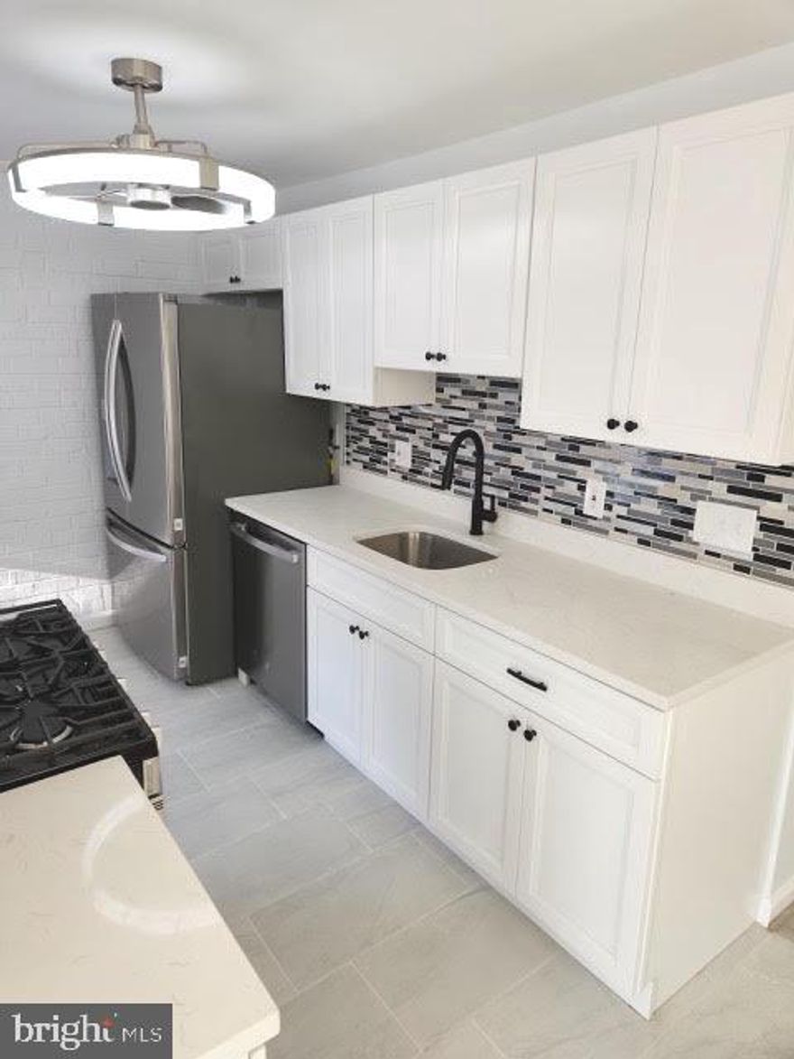 Fully renovated 2-bedroom, 2-bath condo featuring an open floor plan and a generously sized living room. Every interior detail has been thoughtfully upgraded from floor to ceiling. Large windows fill the home with natural light and opens to a private balcony with tranquil views. Both bedrooms offer walk-in closets, and both baths have been completely updated with new tile, modern vanities, LED lighting, and updated flooring. The beautifully updated kitchen showcases a newly added island, energy-efficient stainless-steel appliances, quartz countertops, and a stylish backsplash. Modern trim and finishes, paired with a charming, exposed-brick accent wall, create a warm yet contemporary, modern-rustic aesthetic. Additional upgrades include brand-new luxury vinyl plank flooring throughout, all-new lighting fixtures and chandeliers, added recessed lighting, fresh paint, new window treatments, contemporary shades for privacy, a brand-new HVAC system, and a convenient stackable front-loading washer and dryer. Best of all, ALL UTILITIES are included in the condo fee.  Huntley Square residents enjoy access to an outdoor pool, a party room, and an outdoor BBQ and grill area. The location is close to shopping and dining, National Harbor, MGM, Old Town Alexandria, and Andrews Air Force Base, with easy access to I-495, I-295, and Route 210, offering quick connections to Washington, DC, and Northern Virginia.