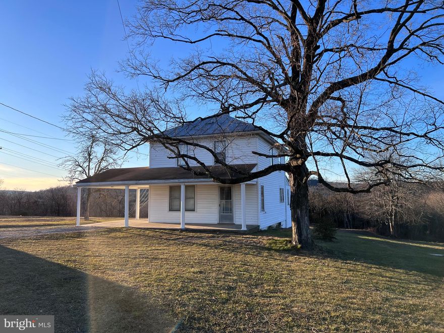 HIGHEST AND BEST OFFER DUE BY 1/18/24  - 5:00 PM.
Farmhouse situated on 9.5 acres with public water and sewer!   Located just minutes from downtown Berkeley Springs along Fairview Drive.   Home features: 3 upper level bedrooms, full bath.  Main level features: living room, dining room, kitchen and enclosed back porch.    Great spot for your farm animals.  Smoke house and chicken house situated on the property.  Explore the possibilities of renovating the Farmhouse OR selling it and building a new home on the remainder of the land.  OR perhaps subdivide the land.