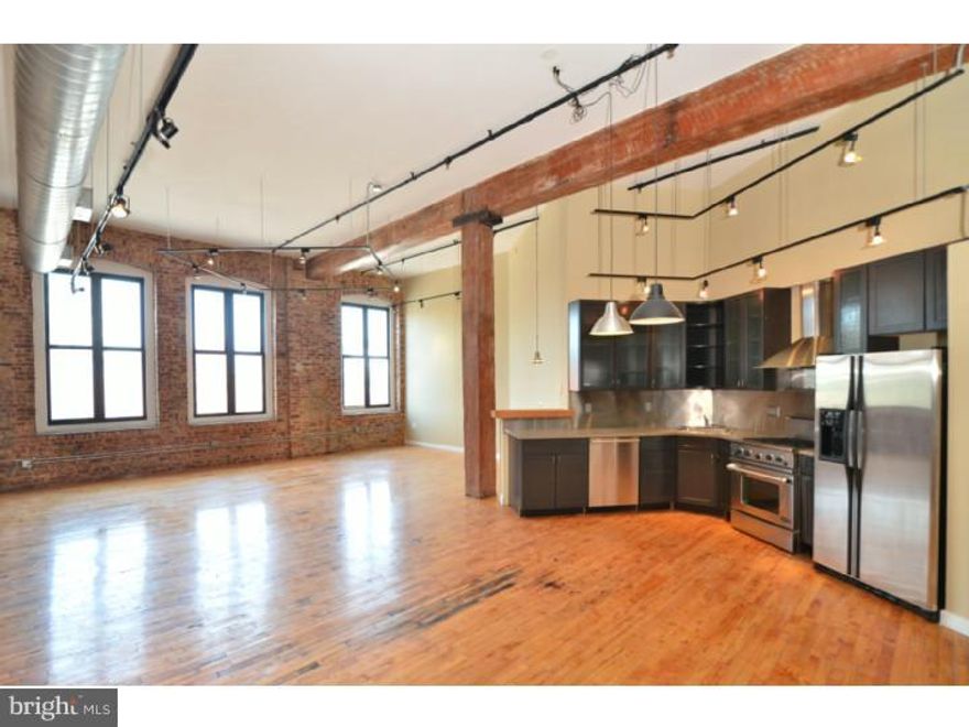 Welcome home! Design magazine-quality corner Loft!! 1400+/- Sq. ft. Over sized windows with abundant natural light. Amazing kitchen with unique glass cabinetry, stone counter tops, and stainless steel appliances. Exposed natural brick, custom steel, cedar-lined closet doors, exposed wood beams, gleaming maple hardwood floors and 3 walls of windows. Ceramic-tile bath with walk-in shower. There is parking on-site with an additional cost. There is a currently a waiting list,BUT! The current owner has leased a spot through the end of 2013, so you have first right to take over your own spot. Inventory in the area is dropping so this condo is going to sell quickly. Parking included in condo fee. Schedule your showing today!!!!!   *NOTE* With an acceptable offer the seller is willing to add a build-out for a private bedroom.