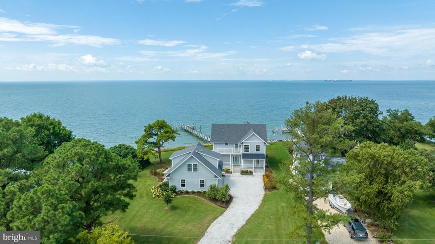 Welcome to this coastal paradise in Fishing Creek, Maryland! Nestled in a serene waterfront community, this 4-year-old home exudes elegance and charm. Boasting 4 bedrooms and 3-1/2 half bathrooms spread across almost 2,600 sq ft, it offers ample space for your family and guests. Inside, you are greeted with an abundance of natural light and sweeping views of Chesapeake Bay and the Hoopers Island Lighthouse, creating an airy and inviting coastal ambiance. The well-appointed floor plan enhances the open living space and maximizes views, with the kitchen, living room, dining area, laundry/mudroom, conveniently located on the first floor. Awaken each morning in the primary suite, featuring a private waterfront balcony, and indulge in the warm breezes floating across the Bay. Guests and young ones will delight in the custom bunk room, which is a child’s dream! An additional waterfront bedroom and central living area on the second floor provide private and restful respite. Each of the oversized bedrooms was designed with comfort in mind, allowing you to unwind and relax in your personal haven. The heart of this home is the gorgeous coastal-style chef's kitchen - perfect for entertaining! Luxurious, functional, and visually striking, it is equipped with stainless-steel appliances and elegant quartz countertops. The centerpiece of the kitchen offers a large island, perfect for meal prep, casual dining, or enjoying a pre-dinner refreshment with friends and family. The family room showcases a custom gas fireplace with built-in TV, floor-to-ceiling built-in shelving, and expansive windows to admire your surroundings. The thoughtful craftsmanship of this home is exceptional and is evident in every corner; every detail is exquisite and exhibits attention to detail and commitment to quality. The oversized 2-car garage provides sufficient space for your vehicles and storage needs, ensuring convenience and organization. Above the garage is a 1-bedroom apartment, complete with top-of-the-line kitchen, living room, custom dining table w/built-in seating, and plenty of storage. The best attributes of this property are the breathtaking, endless views that overlook Chesapeake Bay, providing a sense of tranquility as you soak in the picturesque sunsets. Enjoy the best of coastal living on the screened porch or elevated decks, perfect for relaxation and socializing. Spend a day with friends and family enjoying the waterside saltwater in-ground swimming pool with custom travertine patios and outdoor shower. The 180’ dock with electric, and 12,000 lb lift/4 motors and 2 boat slips bring all your water activities to life. Offers 4.5' MLW at end of dock. Protected rip-wrapped shoreline and custom landscaping with irrigation envelope the entire property. Embrace the tranquil and laid-back lifestyle of shore living and make unforgettable memories in this waterfront retreat. Don't miss the opportunity to call this exceptional home yours—a perfect blend of luxury, comfort, and coastal charm. Come and experience the serenity and splendor that 1113 Keys Road has to offer.