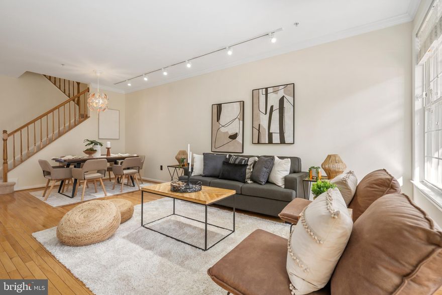 Welcome to this beautifully updated townhome in a gated community in the heart of Pikesville! As you enter, you're welcomed by gleaming hardwood floors and an abundance of natural light, creating a warm and inviting atmosphere. Perfect for entertaining, the spacious living room flows seamlessly into the dining area—ideal for hosting guests. A conveniently located powder room is nearby for added ease. The eat-in kitchen is a chef’s delight, featuring ample cabinet space, a large island for quick bites, tiled backsplash, granite countertops, and stainless steel appliances. Enjoy cozy evenings by the two-sided gas fireplace, shared with an informal dining area. Upstairs, retreat to the luxurious primary suite with vaulted ceilings, a large walk-in closet, and a spa-like bathroom complete with a soaking tub and separate shower. Two additional bedrooms and a full bathroom make a comfortable space for guests, while the laundry room on this level adds extra convenience. The fully finished lower level offers endless possibilities, with a second living room, a recreation room that could be used as a gym, an additional bedroom, and a full bathroom. Step out onto the deck, with irrigation system, off the kitchen, perfect for summer BBQs, and enjoy the ease of an attached garage. This community offers fantastic amenities, including a pedestrian gate to Woodholme Shopping Center,  a putting green and a refreshing pool for hot summer days. Ideally located near Reisterstown Road, 695, and 795, as well as Trader Joe's, Woodholme Shopping Center, and Foundry Row, this home provides the best of comfort, style, and convenience. Don’t miss this gem—schedule your showing today!