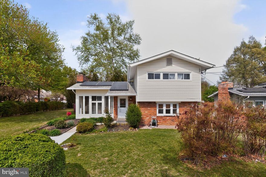 Amazing Rockville location! Spanning over 3,000 square feet, this generous 5-bedroom, 3.5-bath home offers the rare convenience of two primary suites on the main level. Extensive updates throughout make this property truly move-in ready. Key features include a newer 600 sq ft private brick patio built for entertaining and everyday enjoyment, hardwood flooring throughout for a timeless and low-maintenance finish, a chef's kitchen thoughtfully remodeled with a center island, contemporary pendant lighting, and generous storage, luxuriously renovated bathrooms with elevated finishes, and reimagined living and family rooms featuring recessed lighting and fresh flooring. A whole house water filtration system delivers purified water to every fixture in the home. The big-ticket systems are already done, with windows replaced in 2021-2022 and the roof, HVAC, and water heater all updated in 2016. Owned solar panels, installed in 2016 following the roof replacement, are fully paid off with NO loans or liens and convey free and clear to the buyer for immediate energy savings. Inside, the sun-filled living room anchored by a fireplace transitions effortlessly into a warm family room with its own fireplace. A refined formal dining room opens through glass doors to the rear deck, ideal for hosting. Upstairs offers three additional well-proportioned bedrooms with rich wood floors and a renovated bath featuring a corner walk-in shower alongside a spa-style soaking tub. Step out from the kitchen onto the private patio, tailor-made for summer cookouts and gatherings. The fully fenced backyard delivers privacy whether you're unwinding or entertaining. Set on a desirable corner lot with perennial blooms, the home also boasts abundant storage and convenient side parking. A bike trail right out front connects directly to Rock Creek Trails just a couple of blocks away. Perfectly positioned in the heart of Downtown Rockville, the home is within walking distance to Twinbrook Metro Station and sits just steps from Twinbrook Library and Shopping Center with groceries, dining and shops, with quick access to Route 355, I-270.