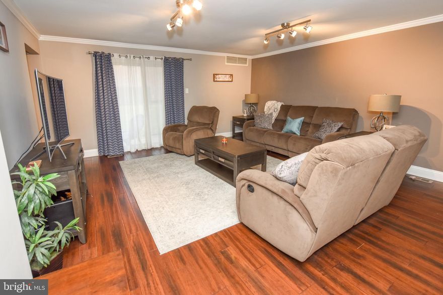 What a beautifully renovated & spacious 2 bedroom condo, located in the very nice development of Hampton Crossing.  New Bamboo Hardwood Flooring throughout the large living room, dining room and kitchen. Brand new stainless steel appliances and completely redone bathroom. New baseboards and crown moldings. Brand new fixtures. The kitchen /dining area has so much space for family gatherings! Both bedrooms are large and both have new carpet. The master has a double closet.  Hallway closet is very big and deep and is used presently as a wardrobe closet. Water Heater 2013. Heater&A/C 2007. Private back patio overlooks a grassy area. Utility Closet is located outside in the porch area.  The condo is located at the very end of the building and is very quiet and peaceful. 1 assigned parking spot, and lots of extra parking in the lot. A beautiful outdoor pool area is a short walk away.  Centennial schools, & the School Bus stops at the entrance to the development.  Included in the Condo Fee: Gas Heat, Gas Cooking, Water, Sewer & Trash Removal. Exterior Building Maintenance and Common Area Maintenance. Grounds are always well kept and some sidewalks have been redone and the remainder will be finished in this year.  So close to transportation & shopping center & restaurants, you could walk there !  Great location and wonderful community to live in.