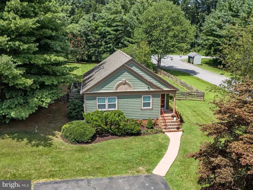Welcome to 693 Thoroughbred Drive — a charming and beautifully maintained ranch-style cottage tucked away on a lush and private 0.55-acre lot in Charles Town. This 2-bedroom, 1-bath home offers a perfect blend of comfort, warmth, and inviting character.

Step inside to an open and airy layout where the vaulted ceilings in the family room and abundant windows fill the space with natural light. The kitchen and dining area flow seamlessly into the living space, creating a bright, connected feel that’s perfect for everyday living and entertaining. Hardwood floors run throughout the main living areas, adding warmth and timeless appeal.

Both bedrooms are conveniently located near the full bath, and the laundry is thoughtfully tucked away in a hallway closet for added ease. Step outside and enjoy the peaceful setting from either the spacious back deck or the lovely screened-in porch — ideal for morning coffee or evening relaxation.

The fully fenced backyard features mature landscaping, a storage shed, and a park-like setting that makes this home feel like a private retreat. Whether you’re looking to downsize, purchase your first home, or enjoy one-level living in a scenic setting, this adorable cottage has it all.

Don't miss your chance to own this little slice of paradise!