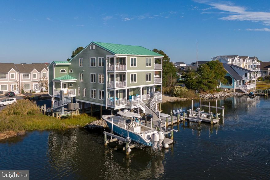 An incredible opportunity to own a stunning and spacious 4-bedroom, 4.5-bathroom waterfront townhome with its own deeded dock and boat lifts. Conveniently located near Fenwick Island on the ditch, it provides easy access by boat, bike, walk or car to Maryland and Delaware beaches. The spacious living room features elegant hardwood floors and offers breathtaking water views, with direct access to your private multitiered deck. For those that like to cook, the kitchen is a true delight. It boasts ample space, stainless steel high end appliances, tile flooring, granite countertops, a built-in microwave, and a wine fridge. The glistening glass-tiled backsplash adds a touch of sophistication to the space. 
This exceptional home features not one but two owner suites, each with its private bath and balcony, providing spectacular water views. The oversized suite on the second floor features a  generous walk-in shower  and a double vanity, while the third-floor owner suite offers vaulted ceilings and additional storage space. Two additional spacious  bedrooms and a den/office offer lots of space to host friends and family and enjoy the beach lifestyle. And on top of that, there are no condo or HOA fees. 
This prime location is a short walkable distance to a variety of restaurants and family-friendly entertainment options. Ready to upgrade your waterfront beach lifestyle. Don't miss this opportunity to own a slice of coastal paradise.