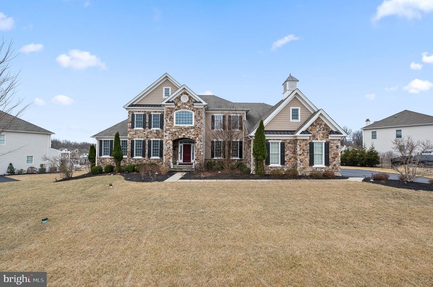 Welcome to 300 Greenbank Lane, a stunning home nestled in the sought-after community of Liseter in Newtown Square. The grand, stone-front elevation “Harding” model offers 5 bedrooms and 4.5 bathrooms, perfectly designed for luxury living and entertaining. As you enter through the airy 2-story foyer, you’ll be captivated by the double staircase and the open floor plan, creating elegance that surrounds you. The foyer is gracefully flanked by a formal living room and a sophisticated dining room with designer light fixtures, setting the tone for this magnificent home. The first floor features a convenient guest suite complete with a full bathroom, walk-in closet, and a cozy sitting area, ensuring privacy and comfort for your guests. (This room would also make a great playroom.) The heart of the home is the expanded, Palladium kitchen, a chef’s dream with its white cabinets, large island, quartz countertops, stainless steel appliances and walk-in pantry. Step outside to the expansive TREX maintenance-free deck, ideal for hosting summer BBQs and enjoying outdoor entertaining. Adjacent to the kitchen, the family room impresses with its dramatic 2-story ceiling and a cozy gas fireplace, creating a welcoming ambiance for family gatherings. A well-appointed office with a ceiling fan and bay window offers a perfect workspace. The first floor is further enhanced by a 3-car garage, a half bathroom, and a convenient laundry room. Upstairs, the second level boasts 4 bedrooms and 3 full bathrooms. The luxurious primary suite is a private retreat featuring a sitting area and a spacious bedroom. Enjoy the indulgence of two large walk-in closets and a lavish bathroom with dual vanities, a soaking tub, a stall shower, and a dedicated make-up area. There are three additional bedrooms, including two that share a Jack and Jill bathroom with a double vanity and a tub/shower combo, and a guest suite with an attached bathroom featuring a stall shower. The unfinished basement has walk-up stairs to the exterior, is plumbed for a bathroom, and the sellers paid a premium to have it dug out an extra foot, offering many possibilities. 300 Greenbank Lane is part of the “Bryn Mawr” collection in Liseter, which allows a fence or a playset. The Liseter community offers a wealth of amenities, including walking trails, a clubhouse, gym and swimming pool, tennis & pickleball courts, and community social events, ensuring a vibrant and active lifestyle. Conveniently located near shopping at Ellis Preserve with Whole Foods, dining, and next to top-rated Episcopal Academy and Marple Newtown Schools. Don’t miss the opportunity to make this stunning Harding model your forever home.