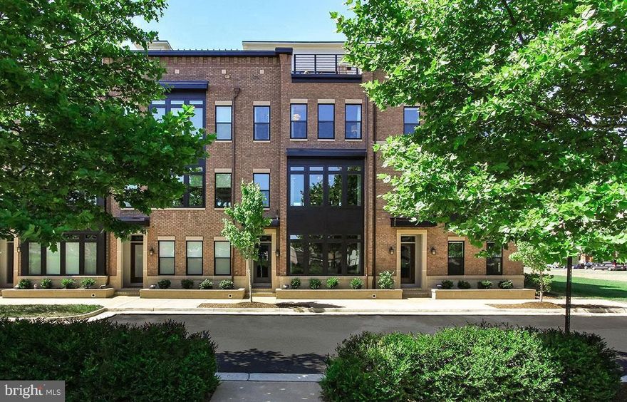 Enjoy luxurious, easy living right in the heart of the Brambleton Town Center. This richly appointed 3-bedroom, 3-full, 2-half bath townhome offers over 3,400 square feet of beautifully finished living space and was built in 2017 as a model home. Used only occasionally as a guest residence, it shows like new! As an exceptional bonus, all furniture and décor are included, including big-screen TVs and a high-end grill, making this a truly turnkey opportunity. From the moment you step inside, the craftsmanship and attention to detail are immediately apparent. Upgrades include wide-plank wood flooring, designer wallpaper throughout, a true gourmet kitchen, premium tile and finishes in the bathrooms, a thoughtfully designed first-floor arts and crafts room, and a private elevator. The entry-level features a spacious home office, an arts and crafts room, and a convenient half bath. The main living level is ideal for entertaining, anchored by a gourmet kitchen with granite countertops, high-end stainless steel appliances, and designer cabinetry. The adjoining family room showcases a statement fireplace and opens to a deck perfect for grilling. A spacious dining area with a built-in butler’s pantry completes the level. Upstairs, the primary suite is a true retreat with two walk-in closets and a luxurious spa-inspired bath. A second well-appointed bedroom with ensuite and a laundry room, conveniently located on the bedroom level, add everyday convenience. The fourth level is an entertainer’s dream, offering a versatile recreation and celebration space with access to a private deck featuring an outdoor fireplace—ideal for hosting friends and family year-round. This level also includes an additional bedroom and a full bath, perfect for guests. The home boasts outstanding curb appeal, a two-car garage, and additional parking. Best of all, the location is unbeatable—just steps from dining, shopping, the Brambleton Library, the LOCO Farmers Market, community events, and more. Located in Loudoun County and served by Legacy Elementary School, Brambleton Middle School, and Independence High School, this home offers the perfect blend of luxury, convenience, and lifestyle.