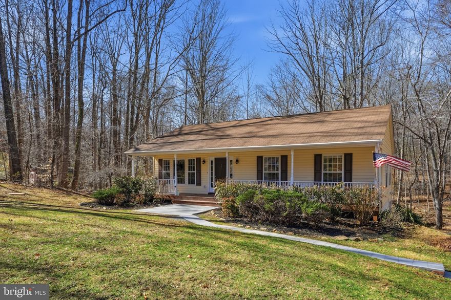 This cozy country home sits nestled in a quiet woodland setting and feels miles away from it all, yet is only about 20 minutes from Warrenton and about 25 minutes from Culpeper. The home is ideally positioned on its 3.06 acres, taking advantage of the privacy provided by the woods and also set well back from the road. 🌳 A broad front porch welcomes you to sit a spell and listen to the birds sing. Inside, a light and airy open floor plan awaits. Cathedral ceilings and lots of windows let in views of the surrounding trees and the expansive front lawn. The living area is anchored by a propane fireplace with a classic dentil molding mantel. There are French doors that lead out from the dining area onto the back deck. The kitchen is open to both the living area and the dining area, and features whitewashed-look cabinetry and a double sink. Rounding out the main floor is the primary suite with its own bath, two additional bedrooms, and another full bath. 🌳 The lower level has a modern "rec room" with a wet bar, lots of windows, and an oversized "French" sliding door. There are two side rooms with one currently used as a playroom and the other as a den or reading nook. At the other end of the lower level, a dedicated mudroom has its own exterior door and is next to the laundry area. There is also an unfinished utility and storage area. A third full bath connects the rec room with the mudroom. 🌳 Escape to your own quiet woodland oasis. Look for wildflowers in the spring, enjoy the cool green light in the summer, watch the leaves turn bright colors in the fall, and discover animal tracks after a winter snowfall. Welcome home!