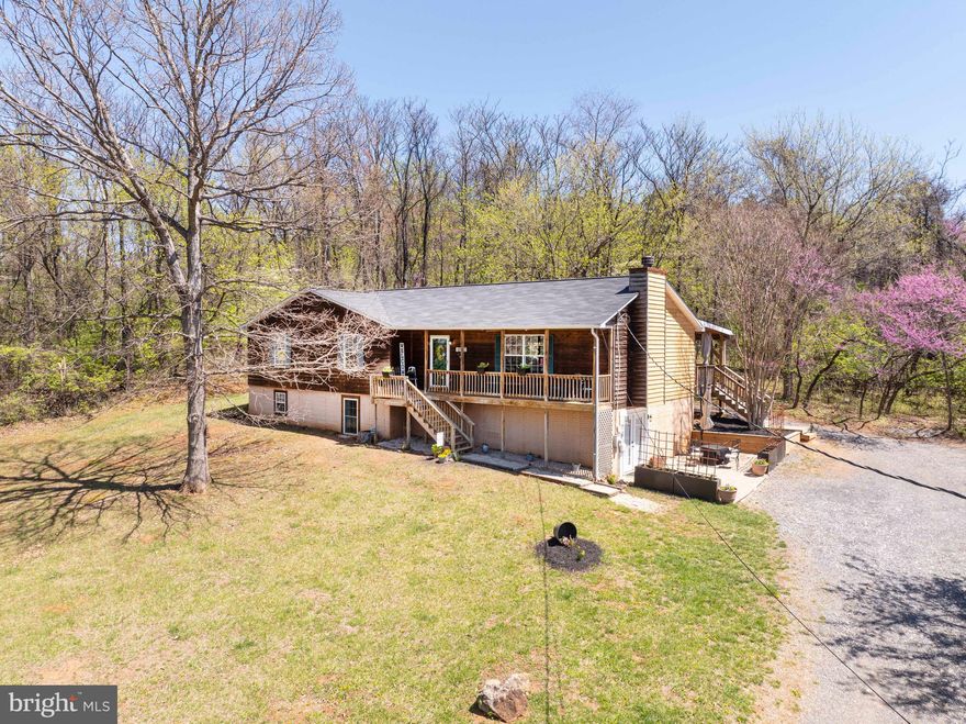 Nestled on a peaceful 3.72-acre lot in the picturesque Blue Ridge Mountains, this 4-bedroom, 3-bathroom home offers the perfect blend of comfort, privacy, and natural beauty. Built in 2001, the residence features a traditional floor plan with a total of 2428 SF of finished living space and an additional 804 unfinished  SF in the basement.
Main floor interior features include a spacious living room with a cozy fireplace, ideal for relaxing evenings, a large open kitchen with breakfast area, main level primary suite with an en-suite bathroom and convenient main-level accessibility, plus two additional well-sized bedrooms and a second full bathroom.
The recently finished, well-appointed basement apartment features a large living room and kitchen (no stove), a large bedroom and bathroom, and an additional queen-sized Murphy bed.  This space currently provides income as a short-term rental, but the possibilities are endless!
If you are looking to enjoy outdoor living, you’ll love the newly covered back deck, perfect for outdoor entertaining or enjoying the tranquil surroundings.  Spend your evenings around the back yard fire pit or sit on the front porch a soak in the sunsets!  
Whether you're looking for a peaceful retreat or a place to grow and entertain, this home is ready to welcome you.  Enjoy the tranquility of country living with easy access to Front Royal's shops, dining, and recreational opportunities.  Don't miss the opportunity to experience the charm of 197 Marissa Ct. Schedule a showing today!